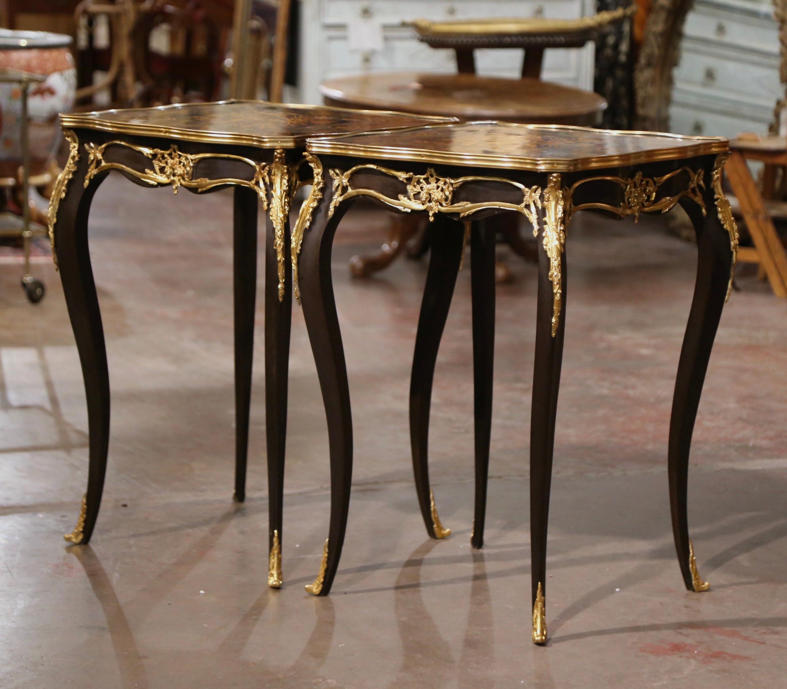 Decorate a living room or den with this elegant pair of antique side tables. Crafted in France, circa 1960 and square in shape with bombe sides, each table stands on cabriole legs embellished with bronze dore acanthus leaves mounts at the shoulder,