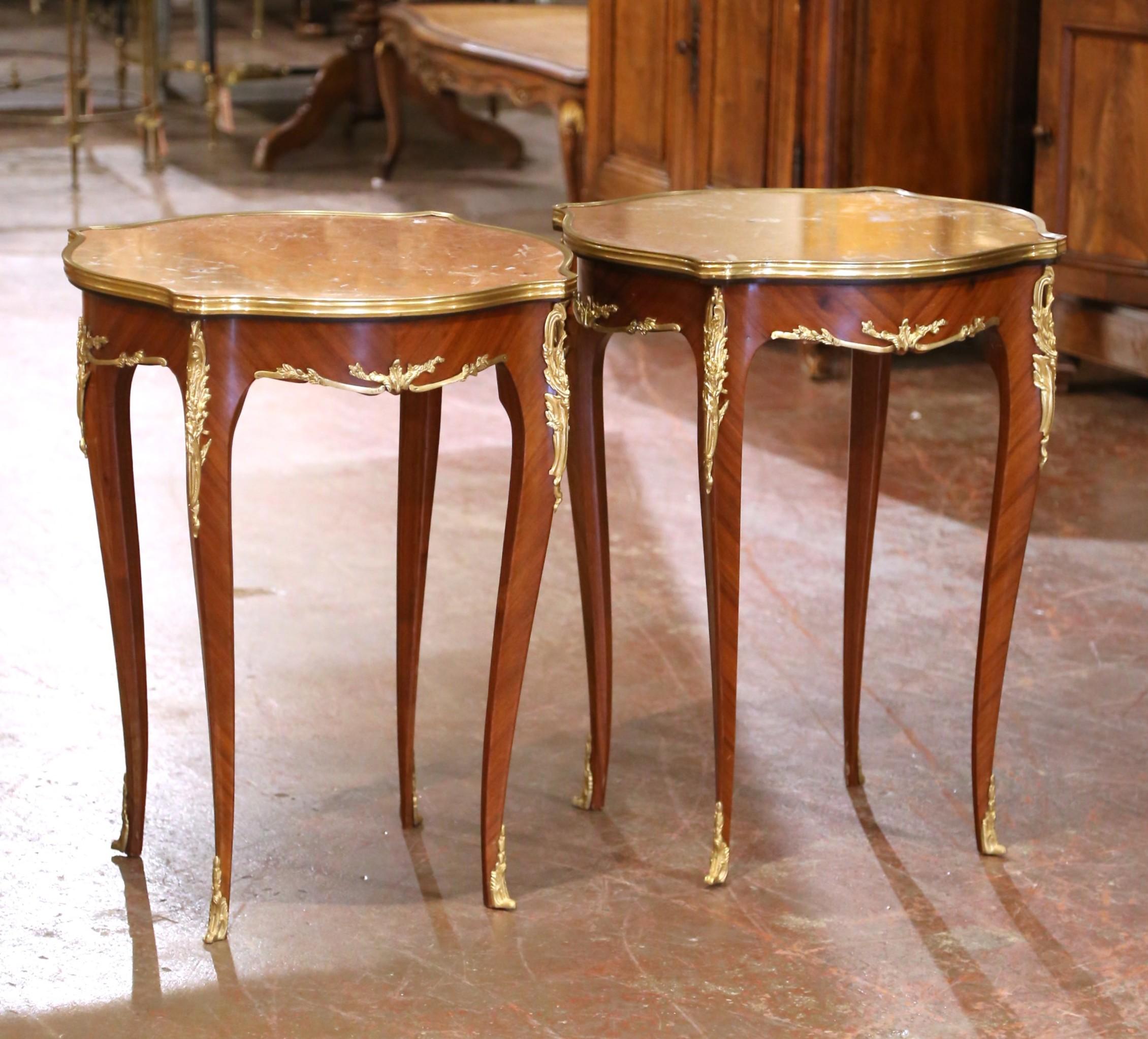 Decorate a living room or den with this elegant pair of antique side tables. Crafted in France, circa 1960 and square in shape with bombe sides, each table stands on cabriole legs embellished with bronze dore mounts at the shoulder, and ending with