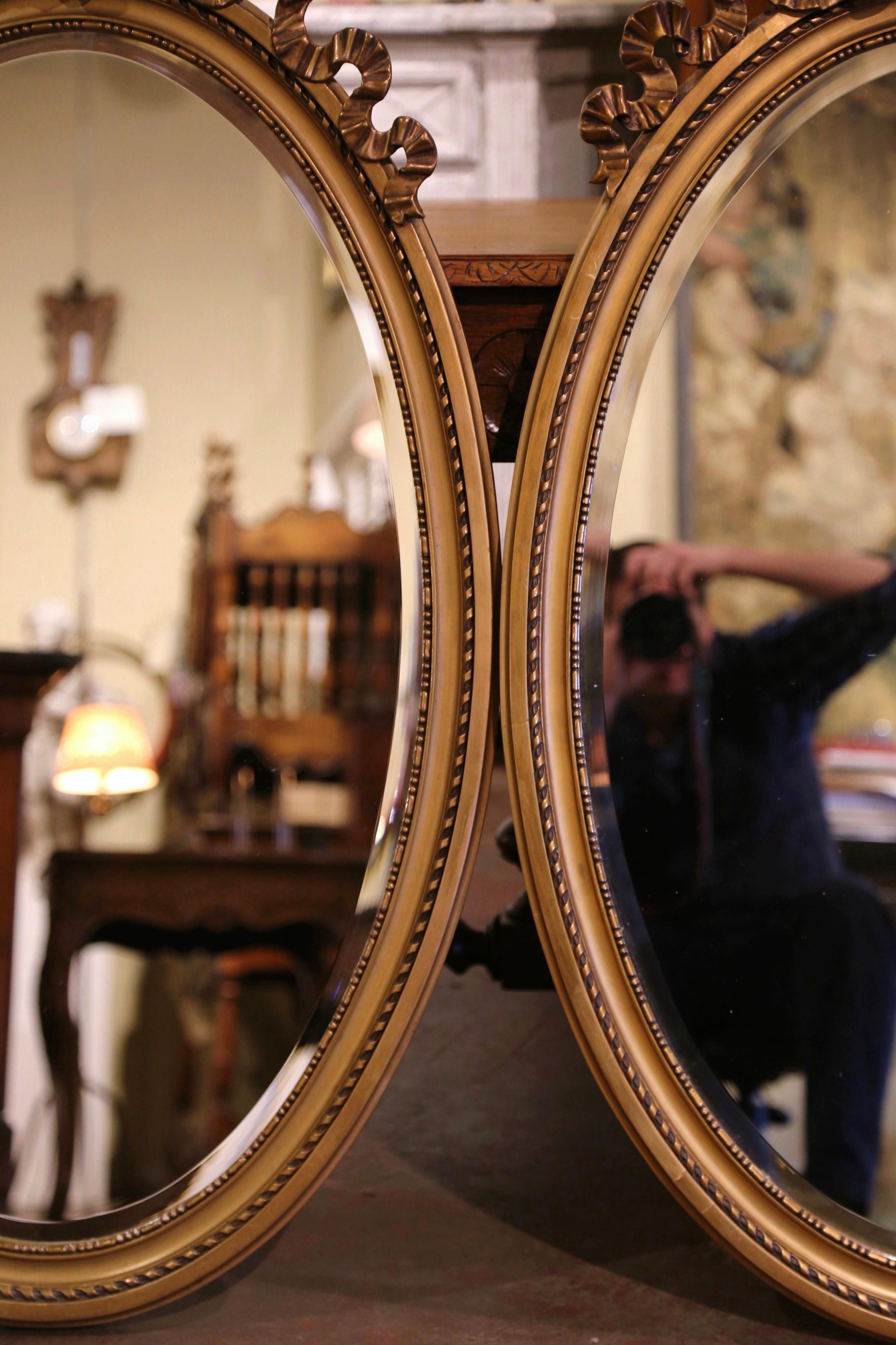 Pair of Mid-Century French Louis XVI Carved Giltwood Beveled Oval Wall Mirrors In Excellent Condition In Dallas, TX