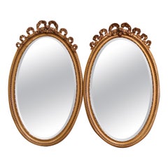 Pair of Mid-Century French Louis XVI Carved Giltwood Beveled Oval Wall Mirrors