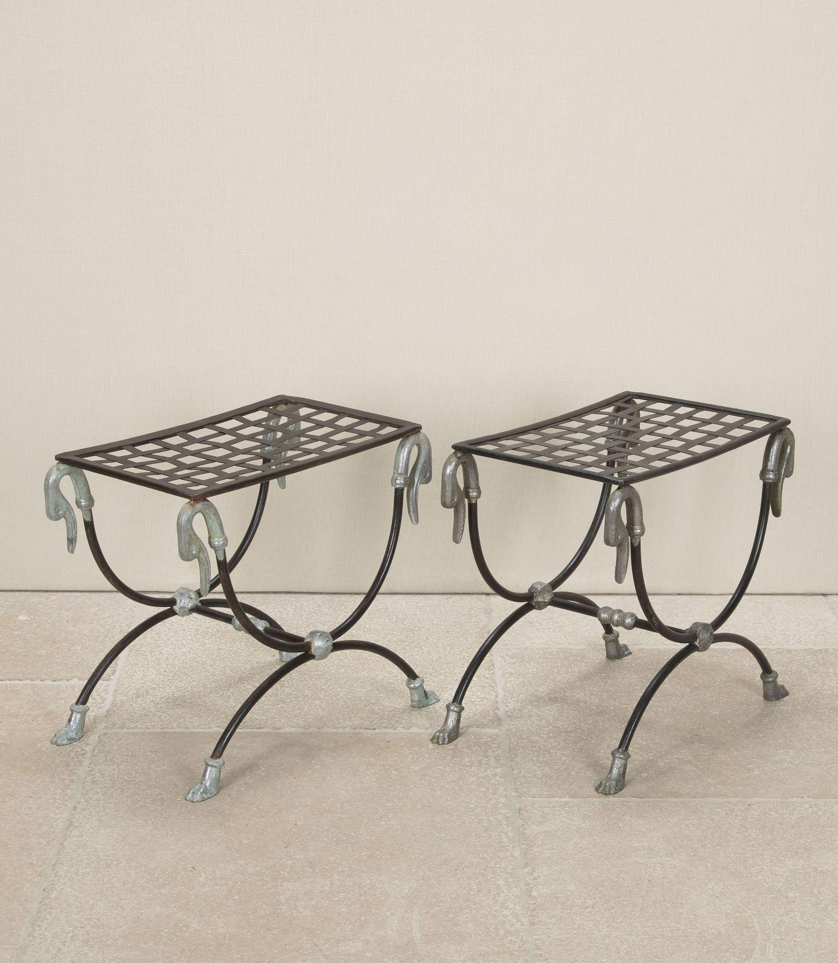 Pair of elegant Mid-Century French wrought iron curule stools attributed to Maison Jansen. They are in the Neo-Classical style and feature cast swan heads and feet with embellishments to the cross stretcher and x-frame. They would also make great