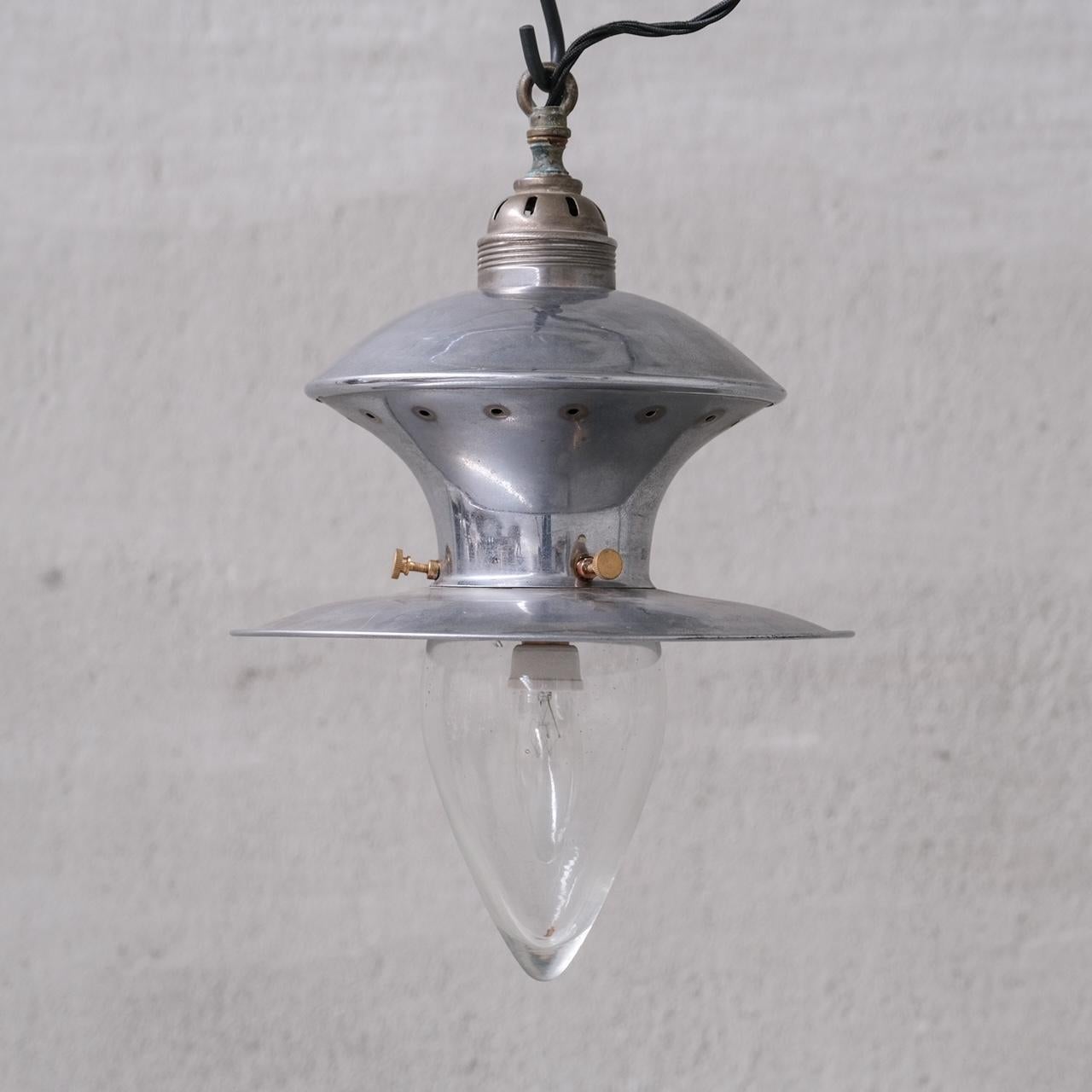 A pair of nickel plated brass and glass pendant lights.

France, c1950s.

Industrial chic.

Price is for the pair.

No rose was retained or chain, however they are easy to source online.

Good vintage condtion, re-wired and PAT tested.

Location: