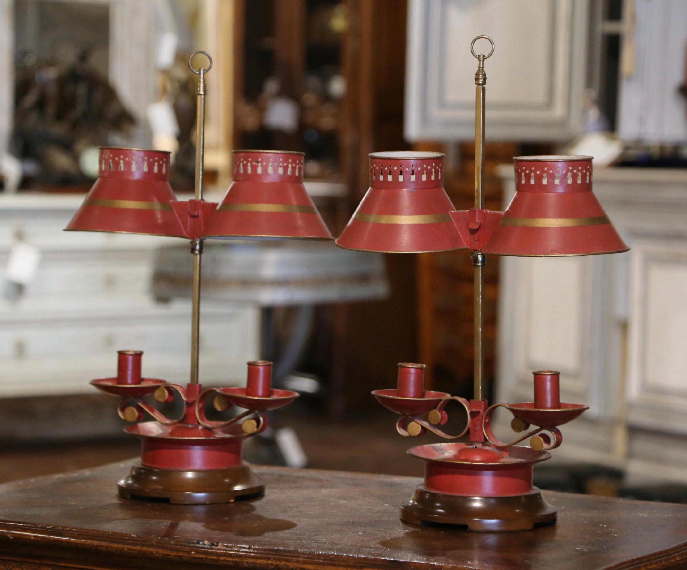 Decorate a console or buffet with this pair of elegant antique candle holders. Created in France, circa 1960, the table lamps sit on a wooden round base decorated with two candle arms over a brass stem. The lamp features two candle holders under the
