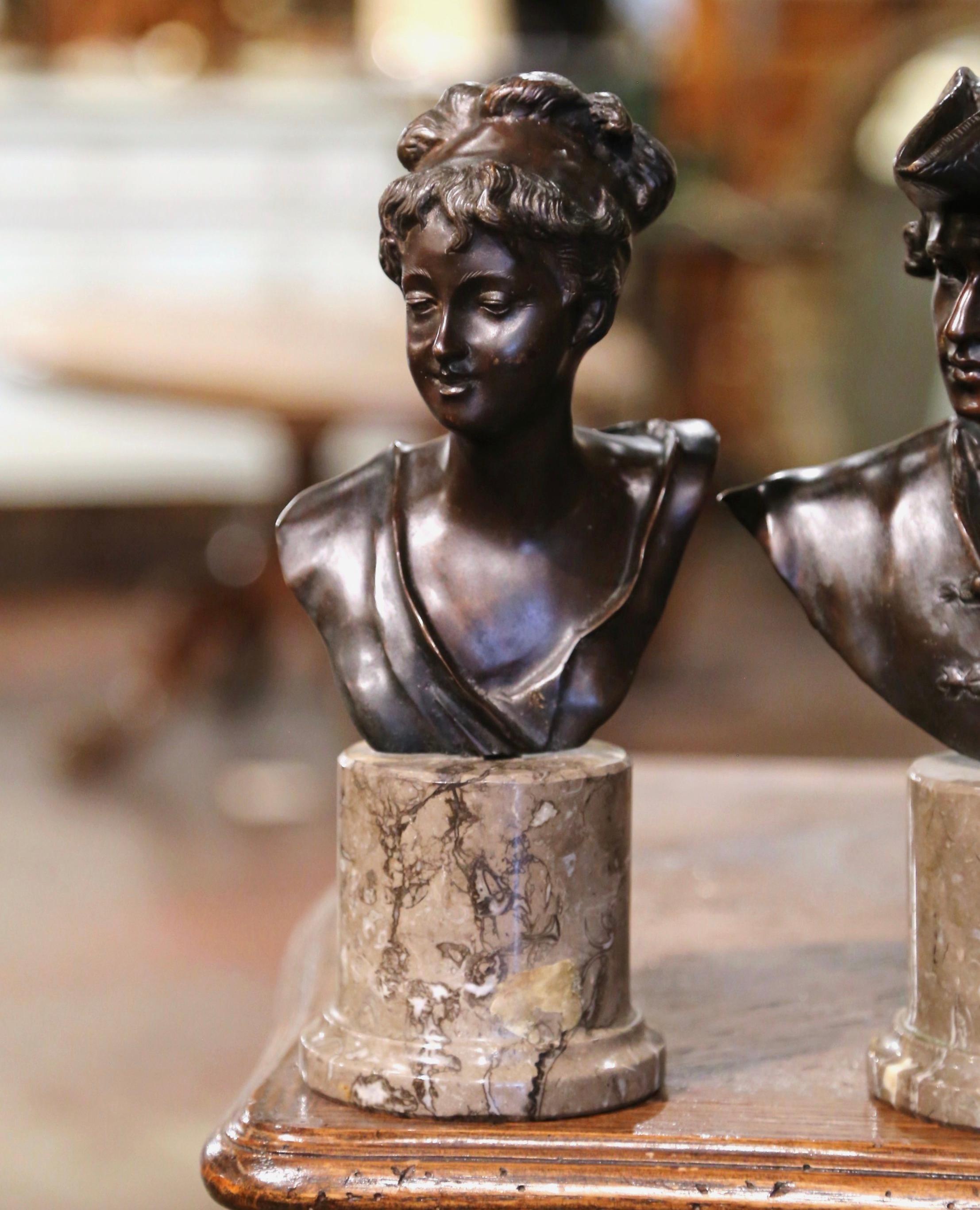 Decorate an office shelf with this elegant pair of antique busts. Crafted in France circa 1950, both subject stand on a circular marble base and depict a Royalty couple in traditional accoutrements. Each bronze figure has wonderful facial