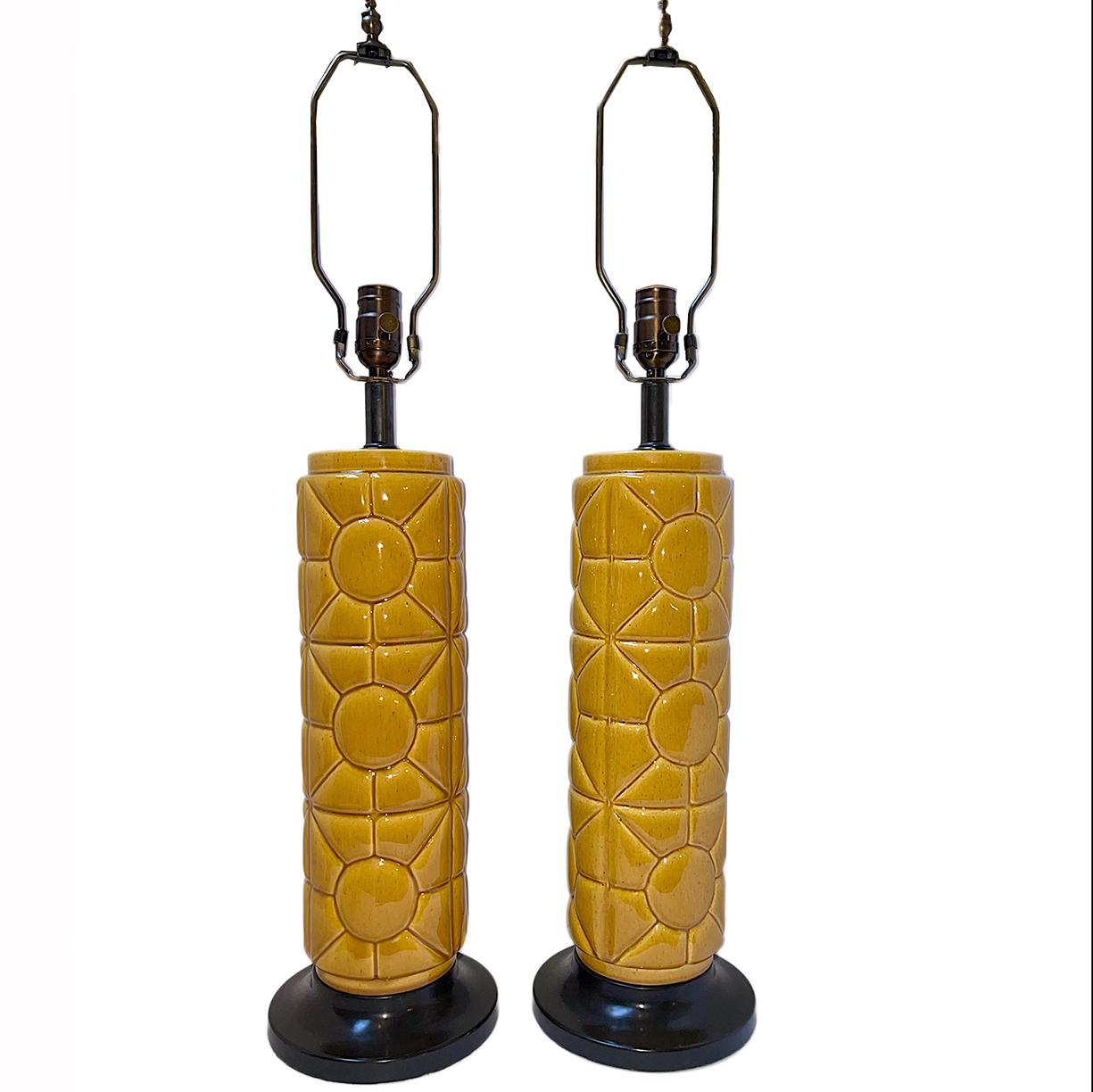 Pair of circa 1950's French porcelain lamps with yellow glaze geometric pattern and ebonized bases.

Measurements:
Height of body: 19.75