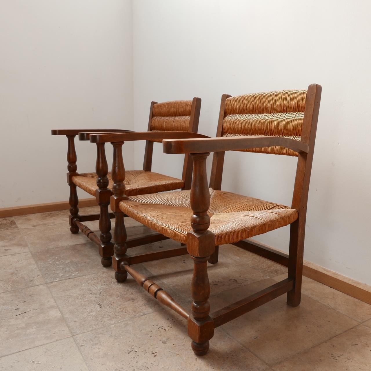 A pair of mid-century armchairs. 

Rush and oak. 

France, c1950s. 

The rush work is in generally good condition with some wear commensurate with age. 

Dimensions: 61.5 W x 60 D x 33 Seat Height x 75.5 Total Height in cm.

Delivery: