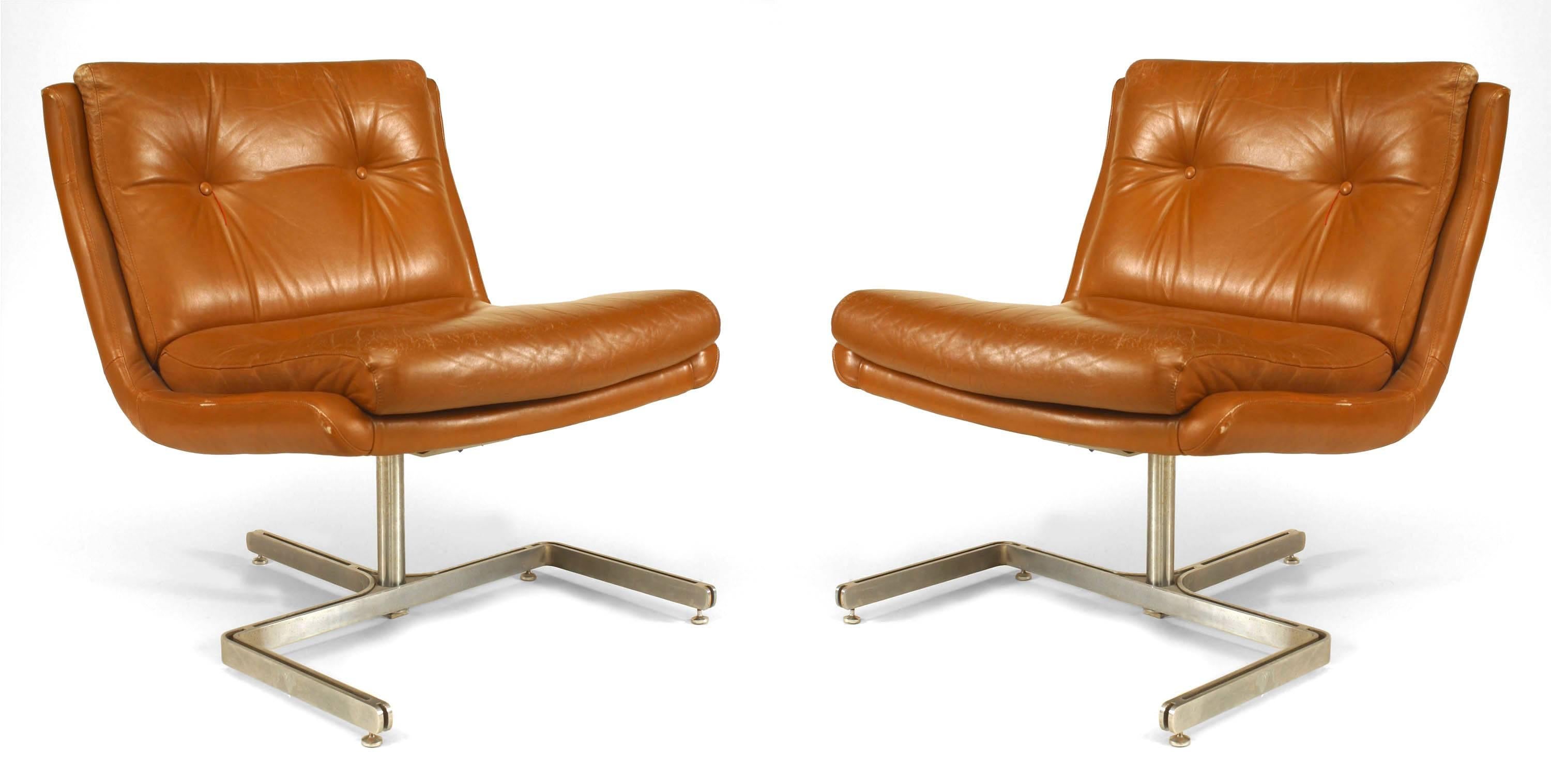 Pair of French Post-War Design side chairs with a scoop seat form supported on a steel pedestal ending in a 3 prong base with brown leather seat and tufted back (att: RAPHAEL)
