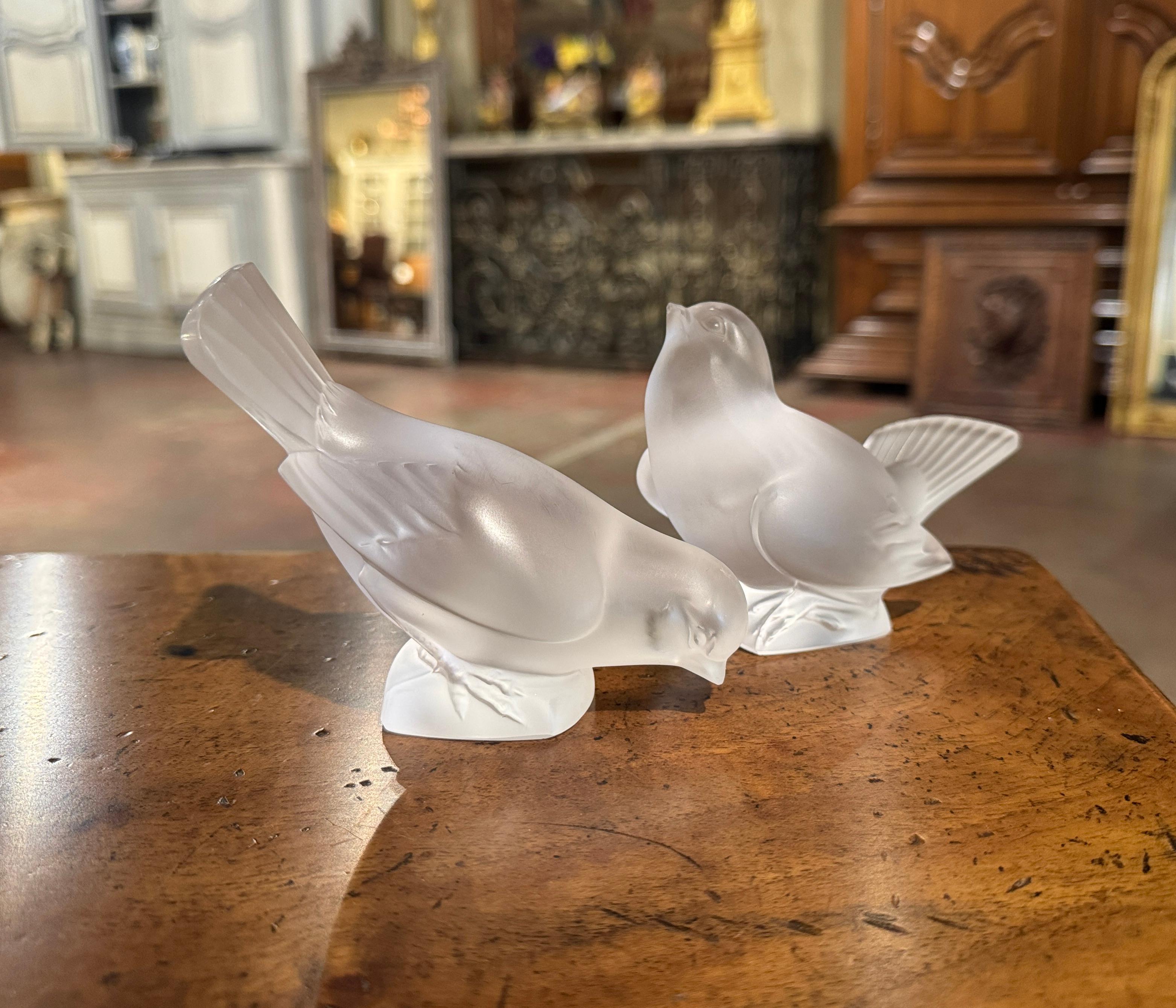 Decorate a shelf or a desk with this pair of vintage bird sculptures. Created in France by Lalique circa 1970, each frosted crystal bird is signed on the base; it includes 