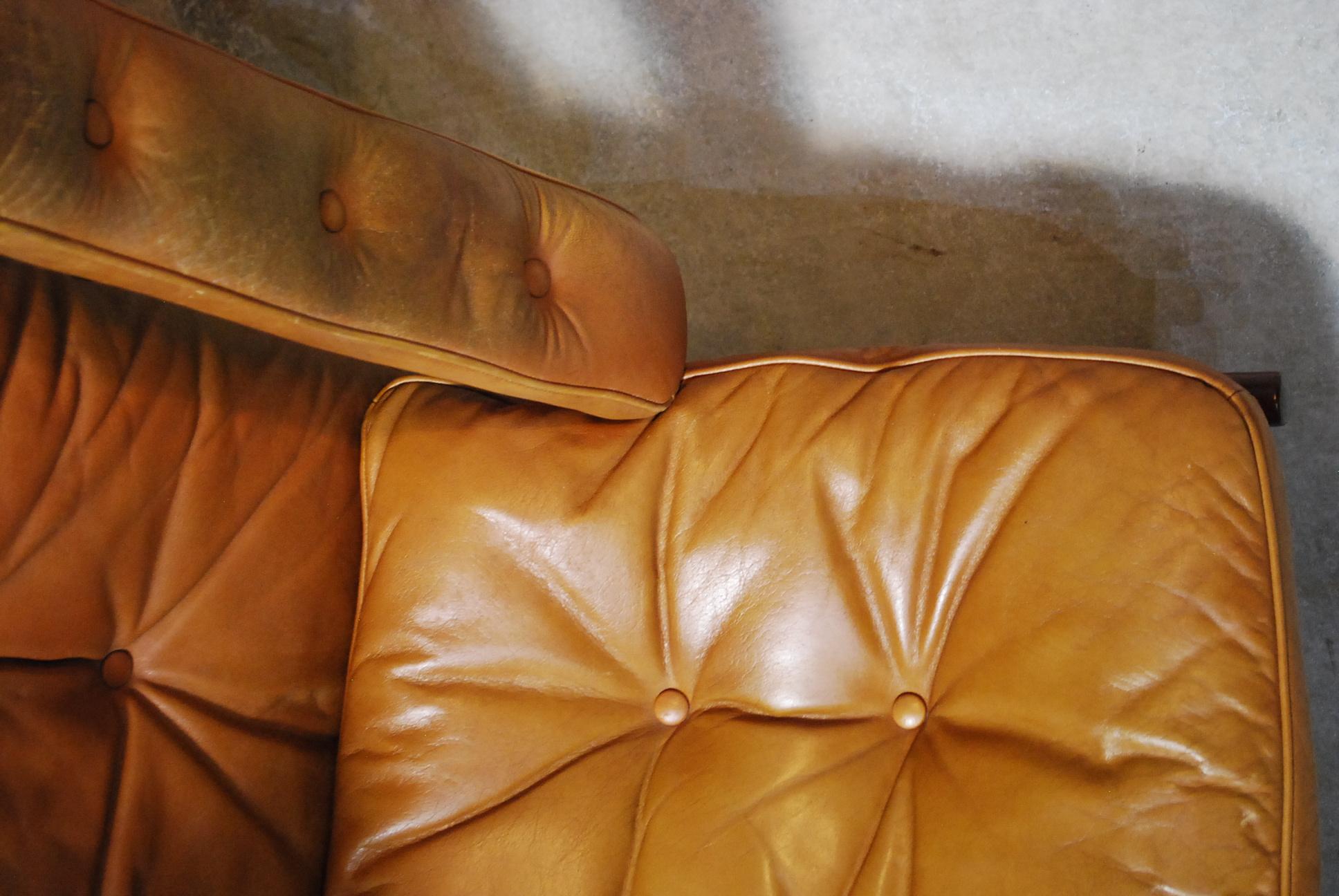 A pair Mid-Century Modern lounge chair made by G-Möbel in Sweden on 
walnut frame with brown leather button-tufted upholstery.

Great worn leather, structurally sound.
