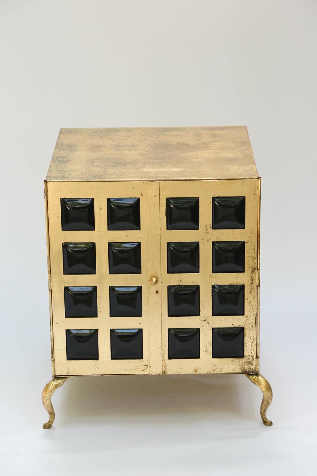 Unusual pair of end tables, each a cabinet of gilt metal, its double doors with grille fronts, inset with 