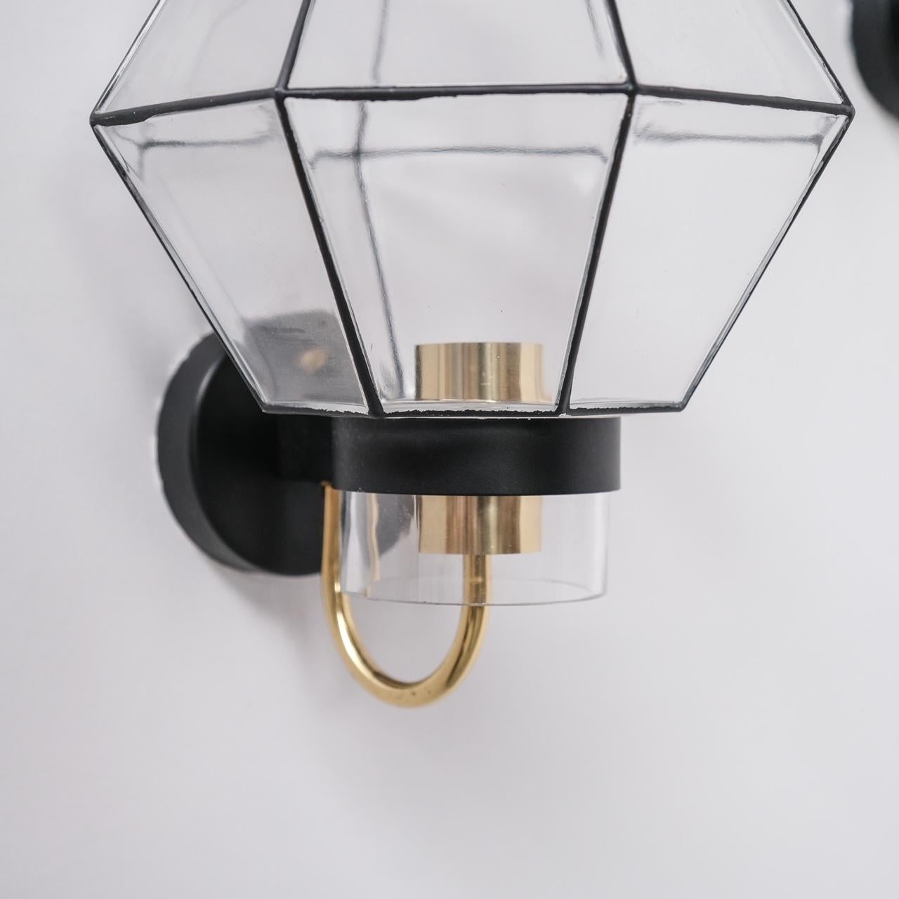 A pair of glass and brass wall lights.

German, circa 1970s.

Produced for Limburg.

Since re-wired and PAT tested.

Location: Belgium Gallery.

Dimensions: 25.5 H x 25 W x 30 D in cm.

Delivery: POA

We can ship around the world. Can