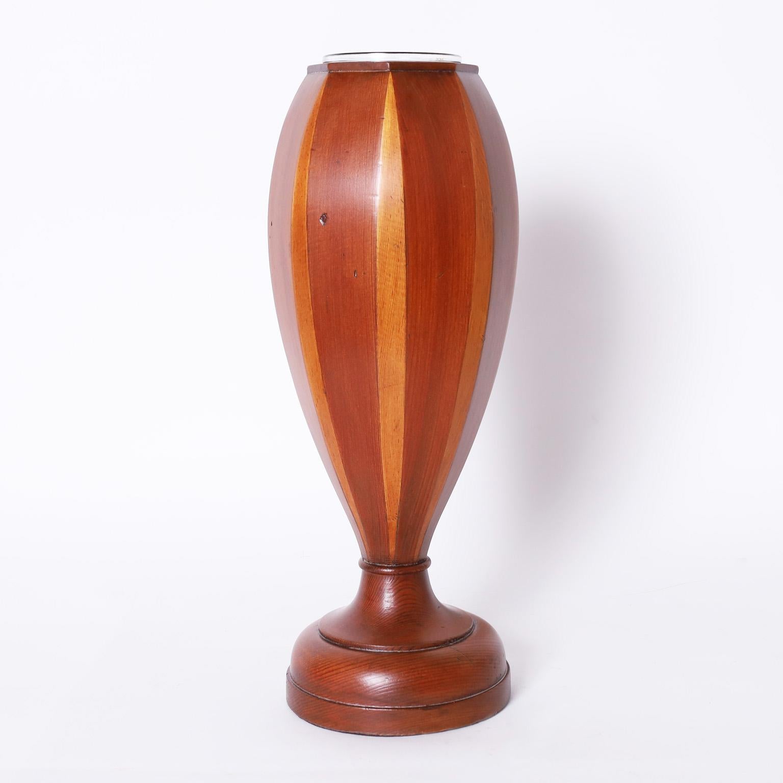 Elegant pair of mid-century vases crafted in stained and unstained mahogany in a sleek modern form with glass inserts on classic turned bases.