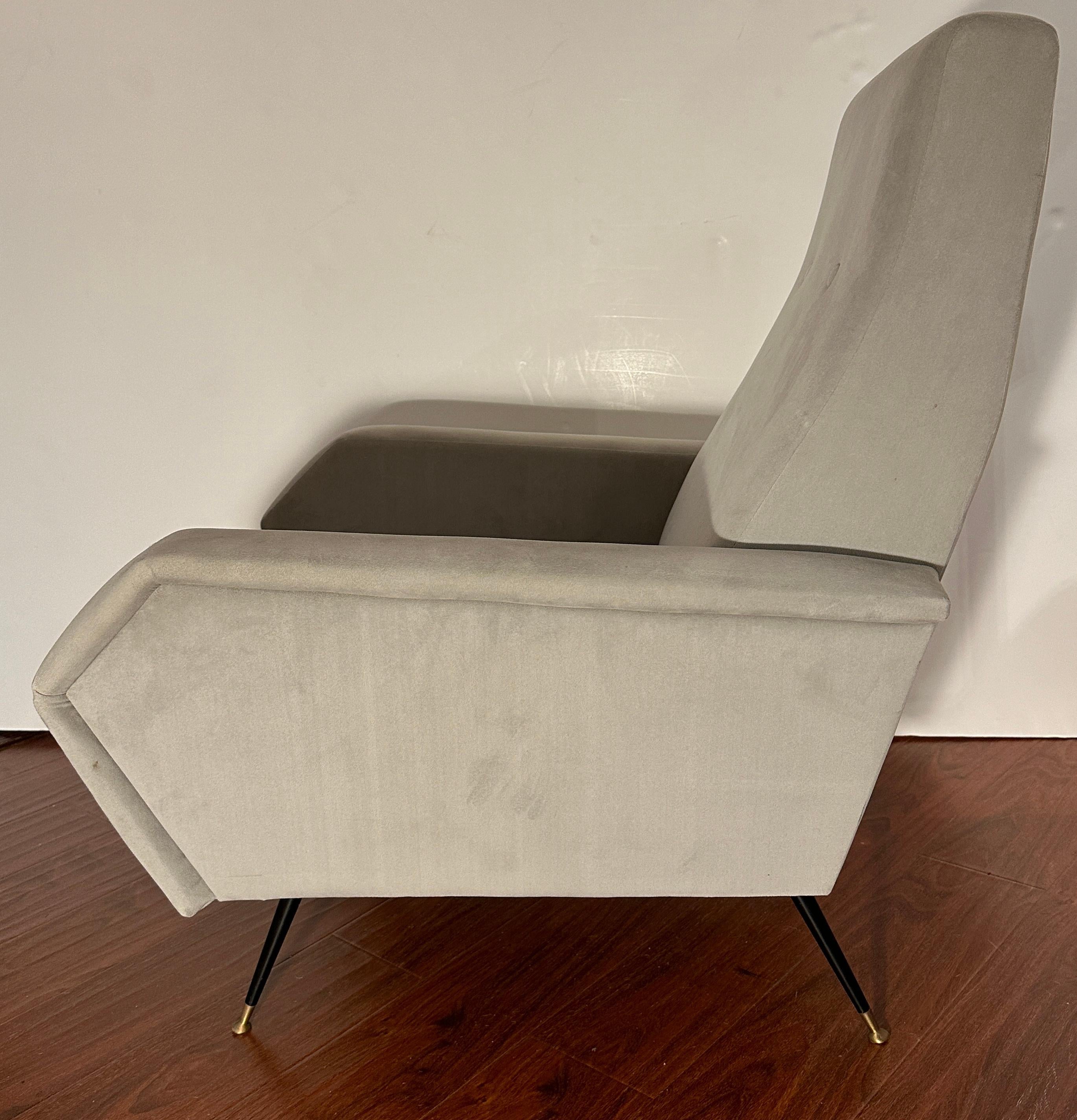 This pair of mid-century Grey Italian Armchairs showcases classic Italian modern design with a contemporary twist.

They boast retro angular lines, creating a striking silhouette. The flared black angled metal legs, featuring iron round fee with