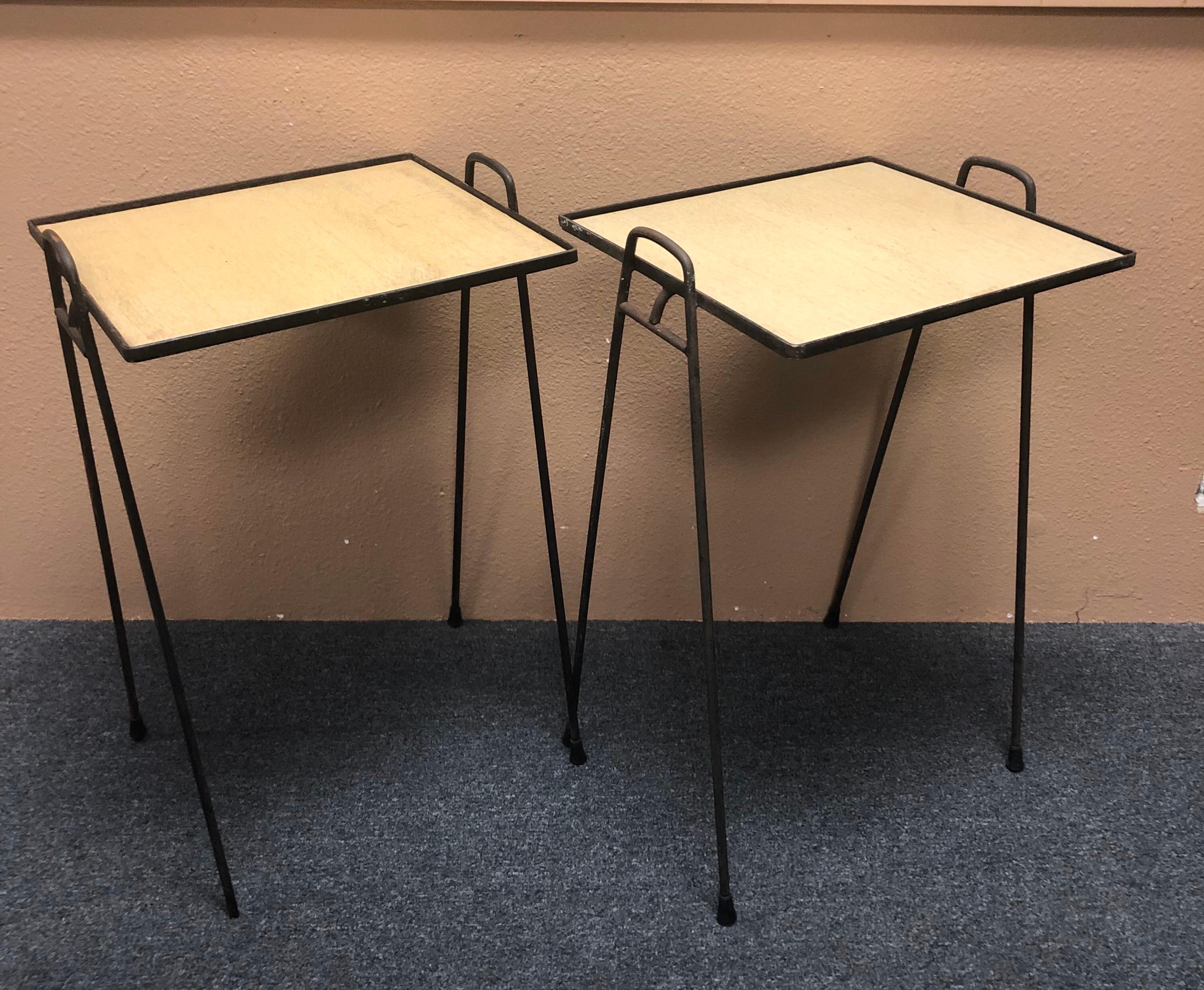A very cool and functional pair of midcentury hairpin stacking TV tray tables, circa 1960s. The table frames are made of welded steel and the tray tops of laminated blonde wood. The set is in fair vintage condition with plenty of patina. Nice rustic