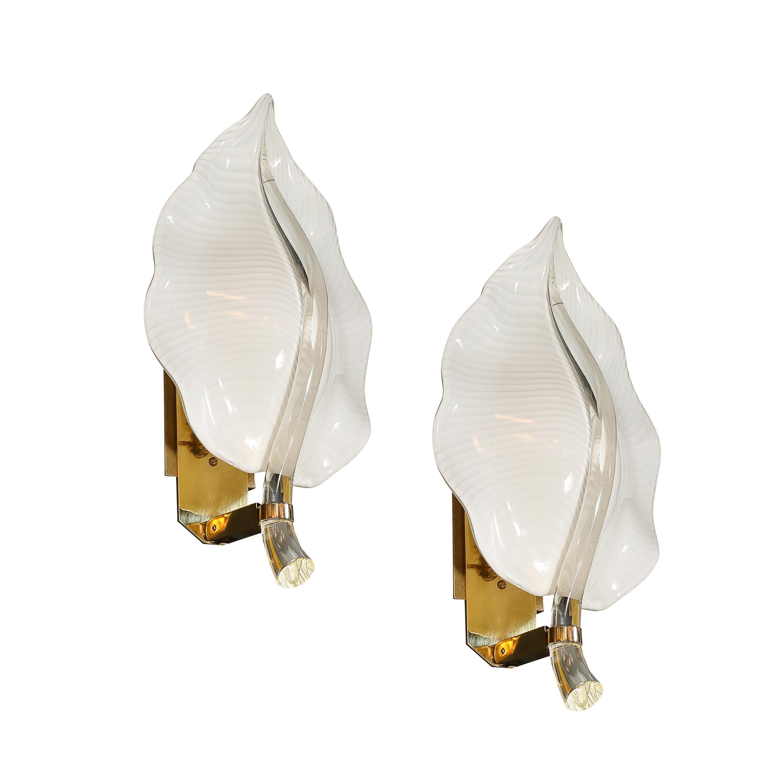 Enhance your living space with this exquisite Pair of Mid-Century Hand-Blown Murano Glass Striated Leaf Sconces by the illustrious designer Franco Luce, Italy, circa 1970. These remarkable sconces epitomize the sophisticated elegance and