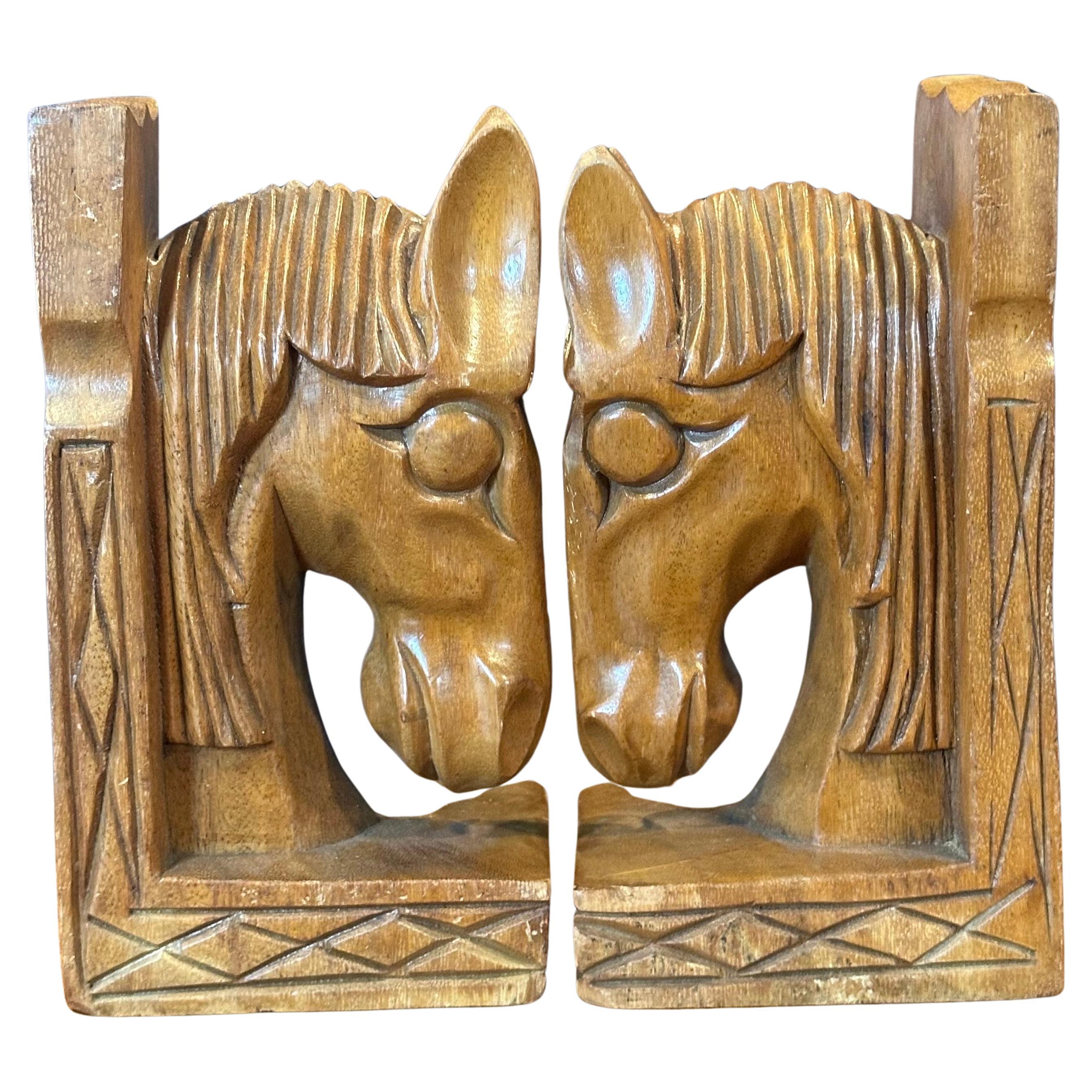 A very nice pair of mid-century hand carved mahogany horse head bookends, circa 1970s. The bookends are heavy, solid and well crafted. They measure 11