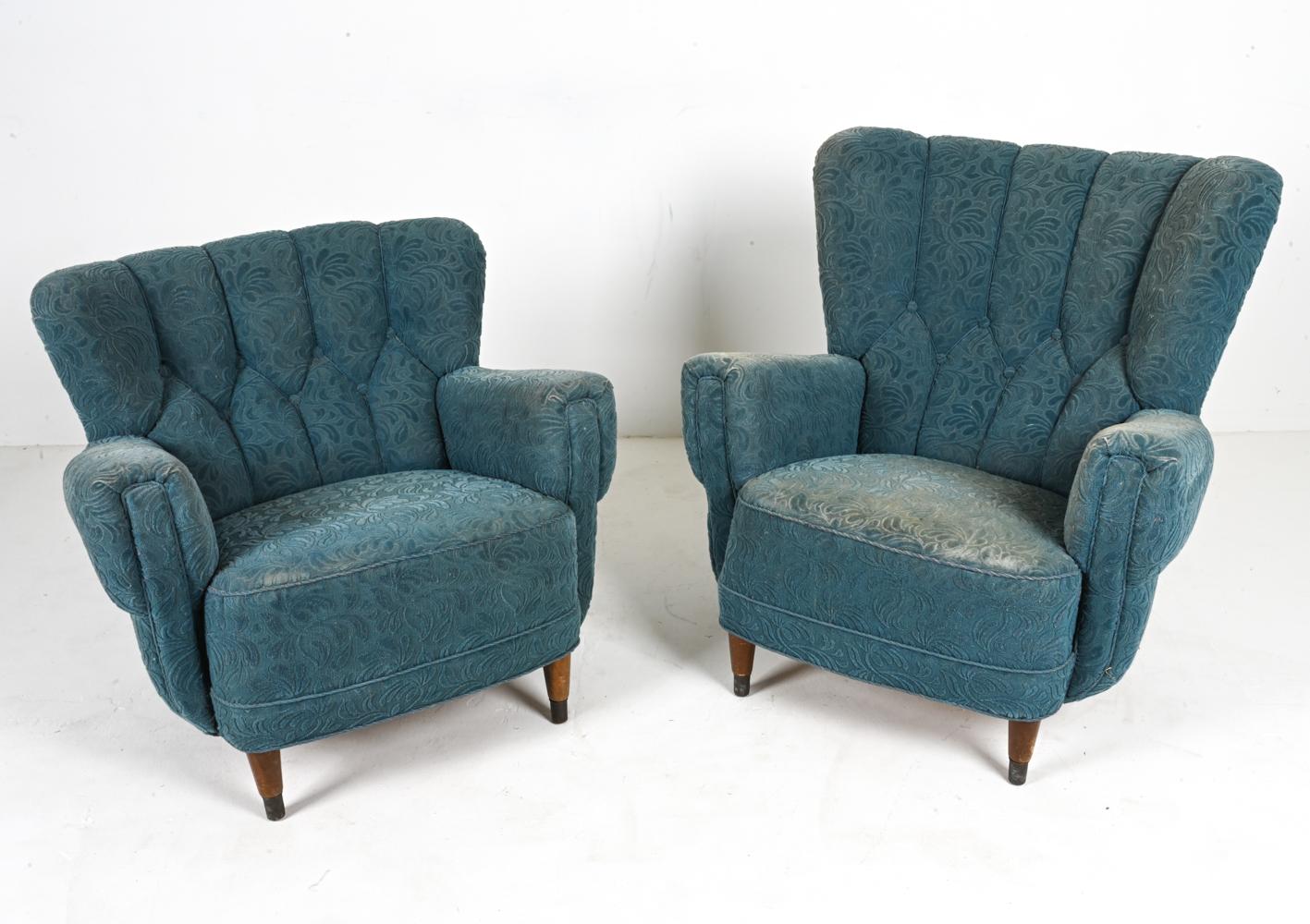 Whispering tales from an era gone by, this pair of Danish mid-century lounge chairs beckon you to a world where elegance was etched in every fiber and artistry arose from every curve. Drawing inspiration from the iconic style of Flemming Lassen,