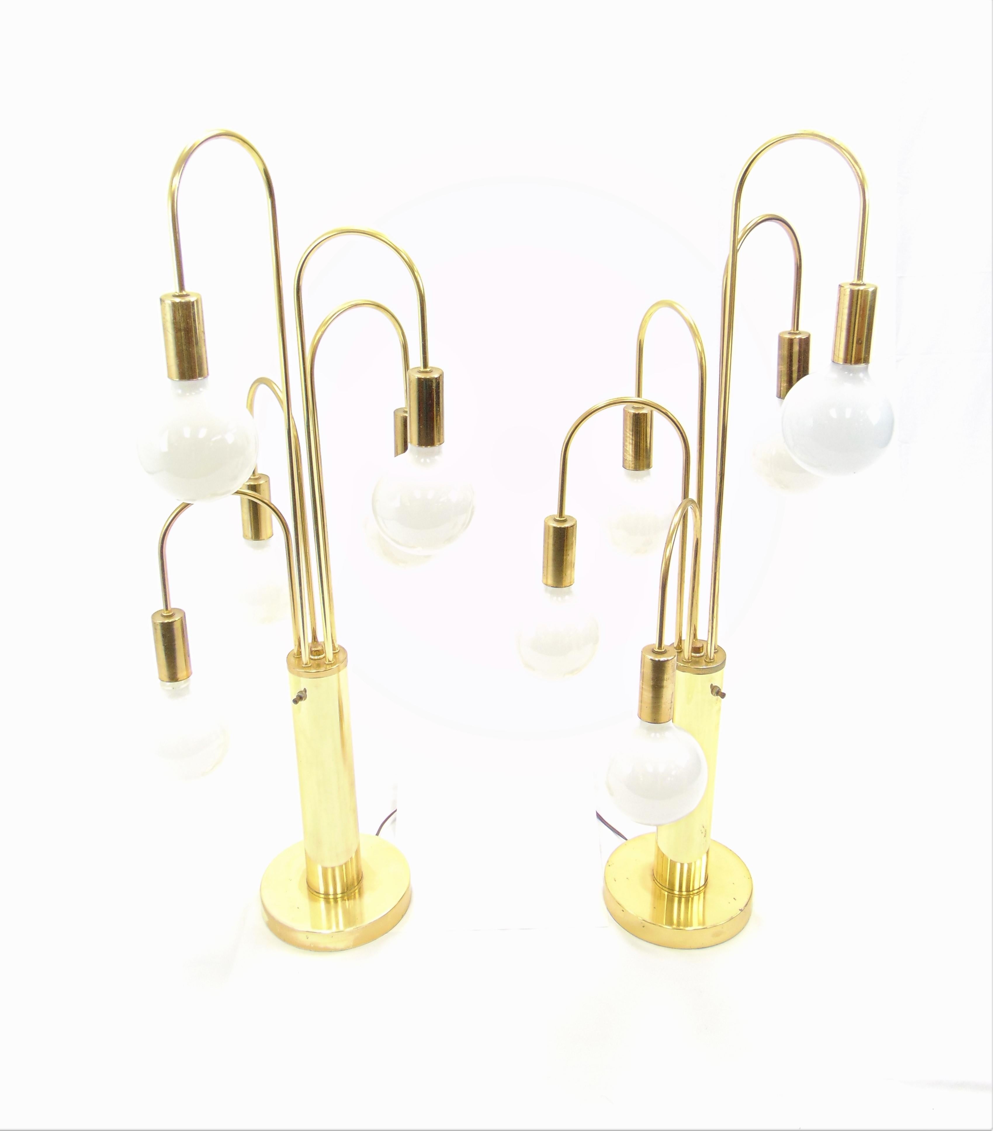 These are a very fun pair of vintage midcentury lamps in the Hollywood Regency style. Each lamp has 5 large bulbs. These lamps have three different settings. You can have two lights on, with another click you can have 3-light on, and with a third