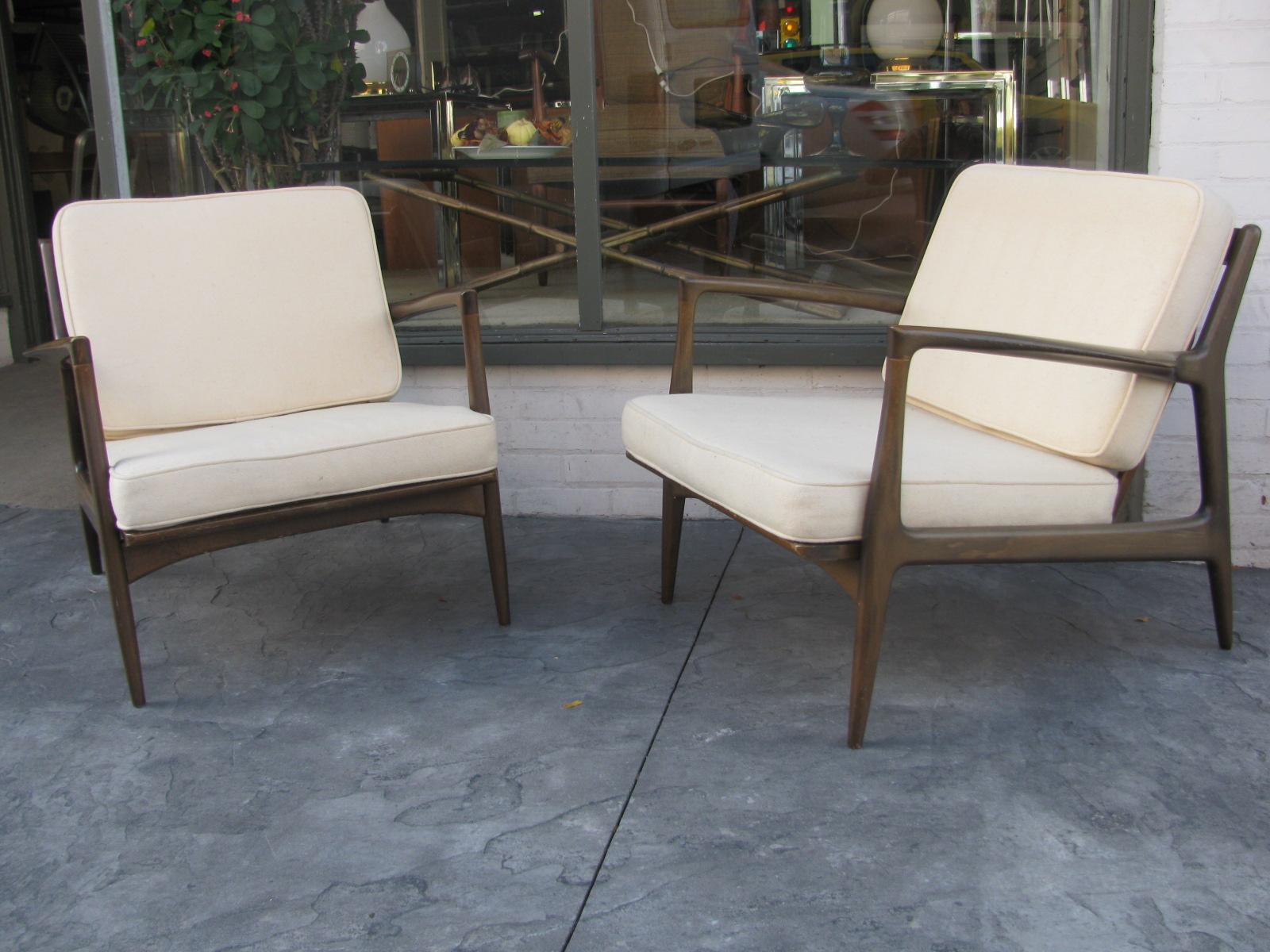 Pair of deep seated sculpted lounge chairs designed by Ib Kofod Larsen for Selig. Very comfortable to go with the great style of Denmark from the fifties. Cushions, fabric is in very good condition with minimal wear, foam is like new. Wood (Beech),