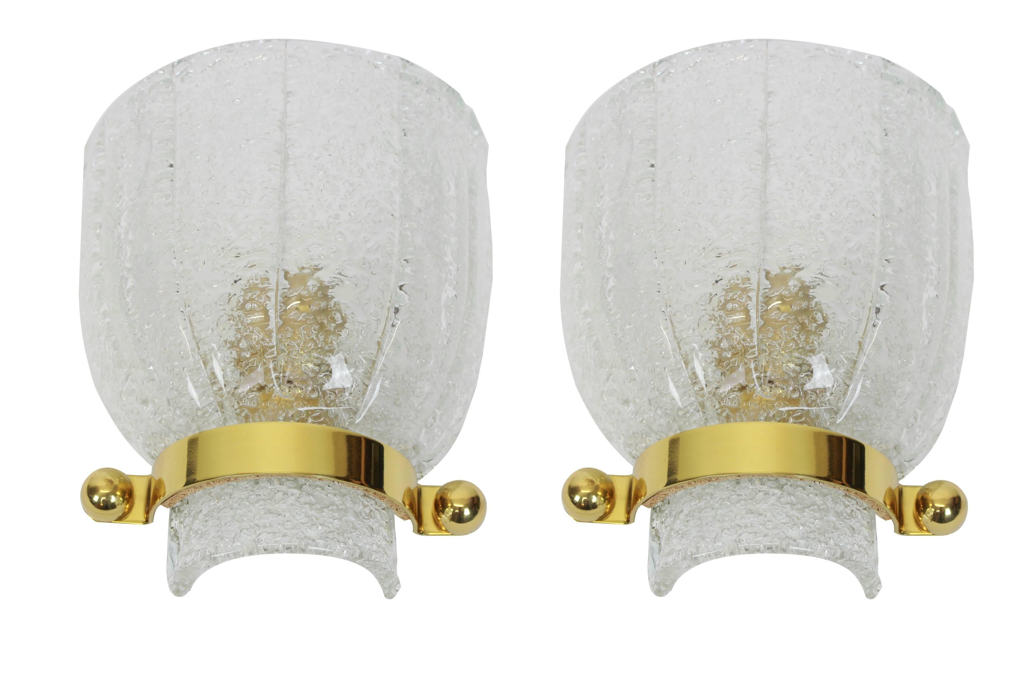 Wonderful pair of Mid-Century brass wall sconces with ice glass, made by Kalmar, Austria, manufactured, circa 1960-1969.

High quality and in very good condition. Cleaned, well-wired and ready to use. 

Each Sconce requires 1 x E14 Standard