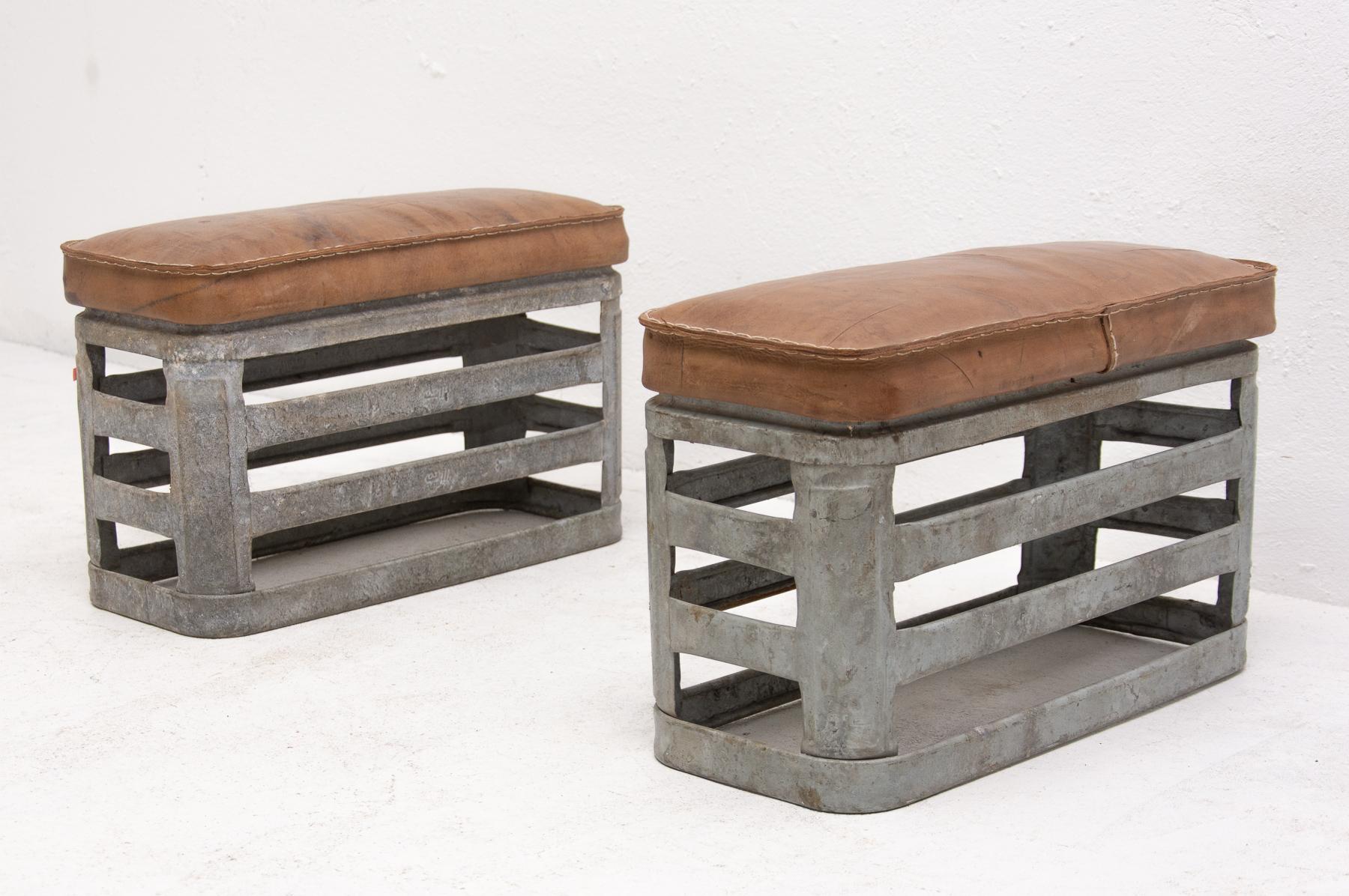 Pair of Czechoslovak Vintage industrial stools, made in the 1960s. It features an unconventional design. It features a metal structure with leather cushion on the top. In good Vintage condition, bears signs of age and using with a nice patina. Price