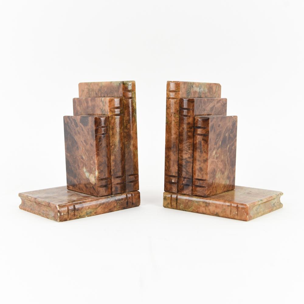 These fabulous bookends mimic the look of emperador marble (or a leather-bound book!) with rich brown tortoiseshell alabaster. Hand carved in the form of stacked books, they make the perfect accent to any library or bookshelf. Labeled 
