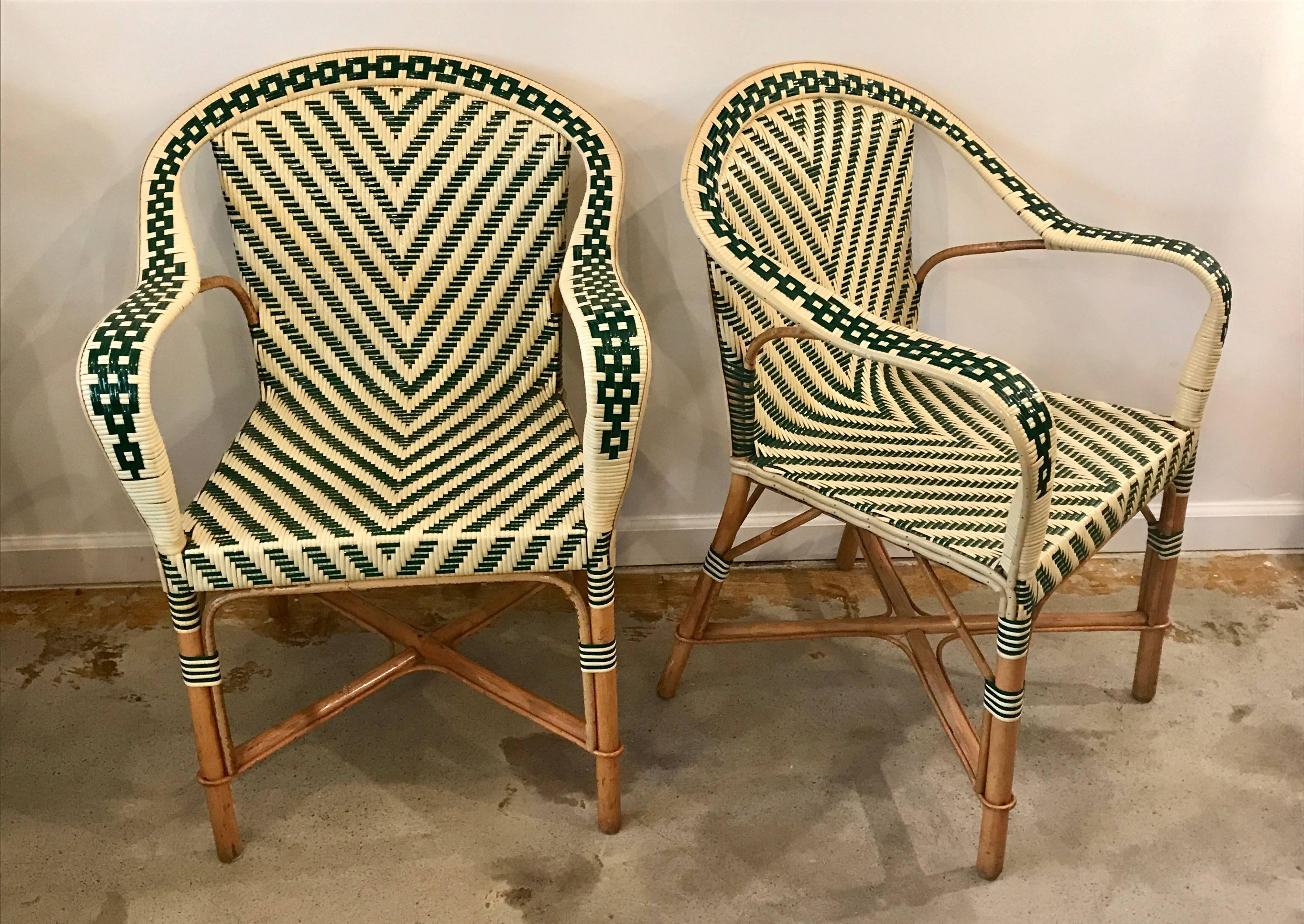 Amazing pair of French armchairs with vinyl wicker rattan chevron two tone pattern, intricately woven on beautifully shaped bamboo frames.