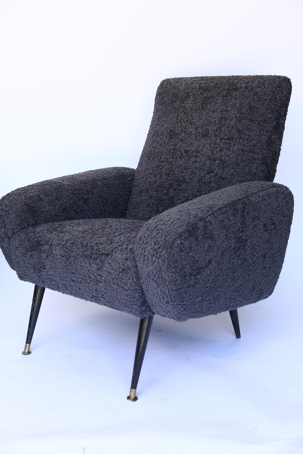 This pair of Mid-Century Modern Italian armchairs in the style of Marco Zanuso have been newly upholstered in Lee Industries Sherpa Coal fabric. The legs of the chairs are made of tapered wood; the front legs have a brass 