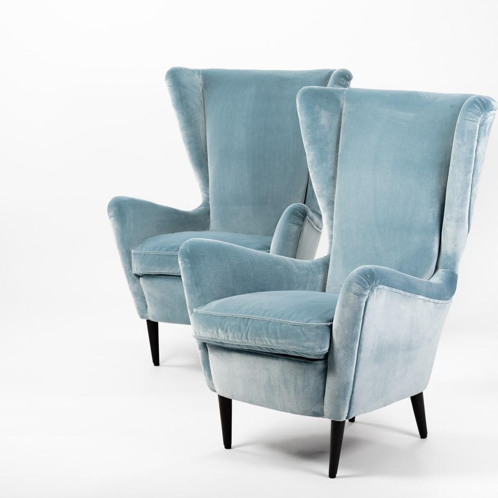 Pair of excentric shaped armchairs by ISA, Bergamo 1950s.
The lovely Italian design language is underlined by the powdery, soft velvet fabric Martora in turquoise-acqua color 
by Rubelli, Venezia.
The seating comfort is very pleasant due to the high