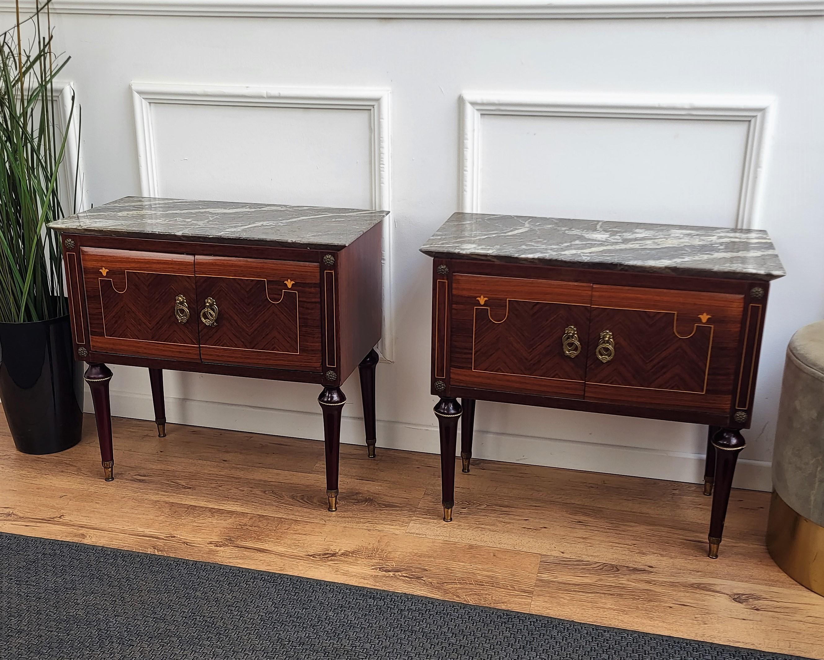 Very elegant and refined Italian 1950s Mid-Century Modern, neoclassical and empire style, in typical Art Deco design, pair of bedside tables with wood double front door, Portoro marble top and inlay decors on the sides and doors, and brass details