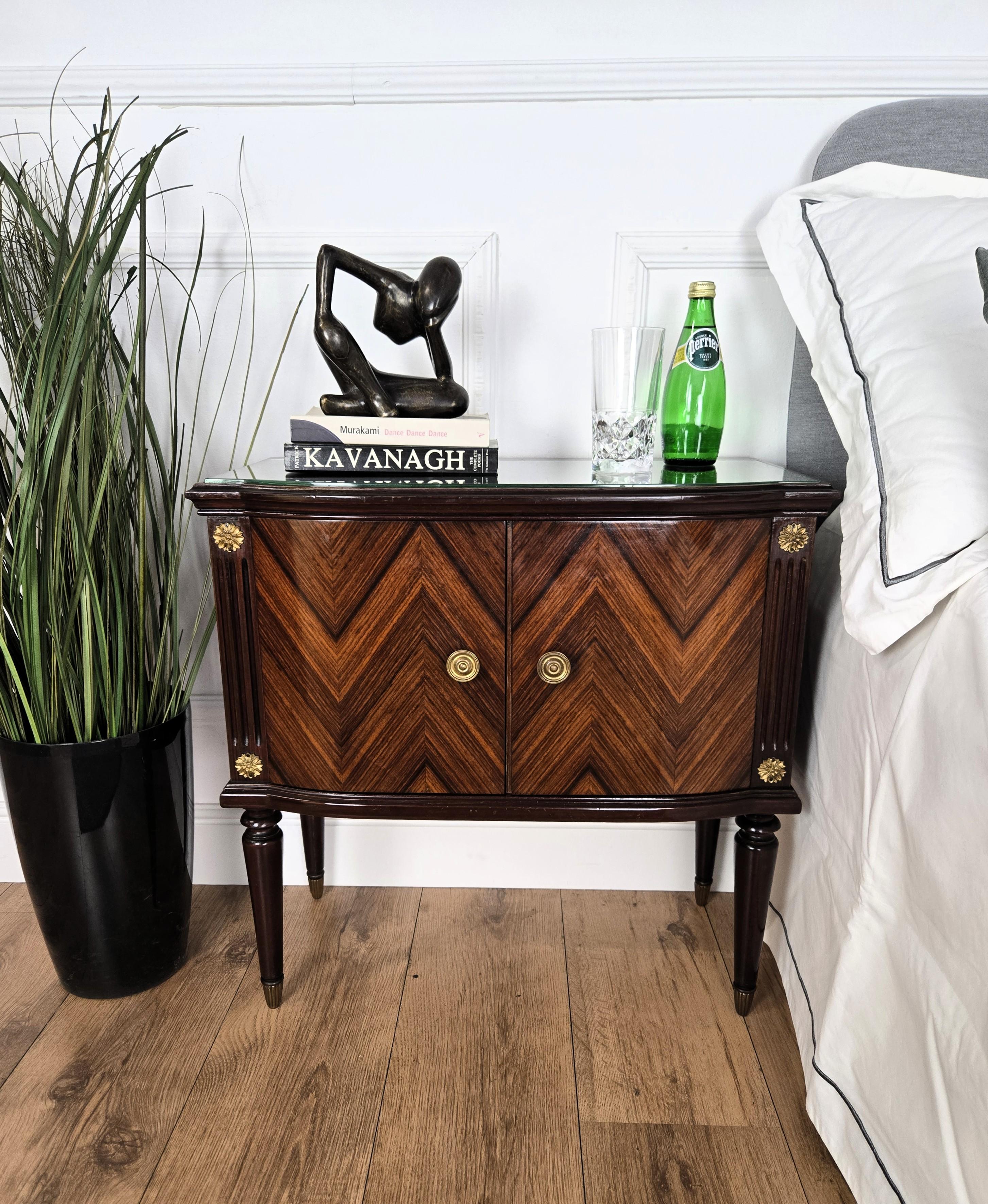 Très élégante et raffinée paire de tables de chevet italiennes des années 1950 au design Mid-Century Modern, avec double porte frontale, plateau en verre et magnifiques décors en loupe de placage de bois sur les côtés et les portes, mis en valeur