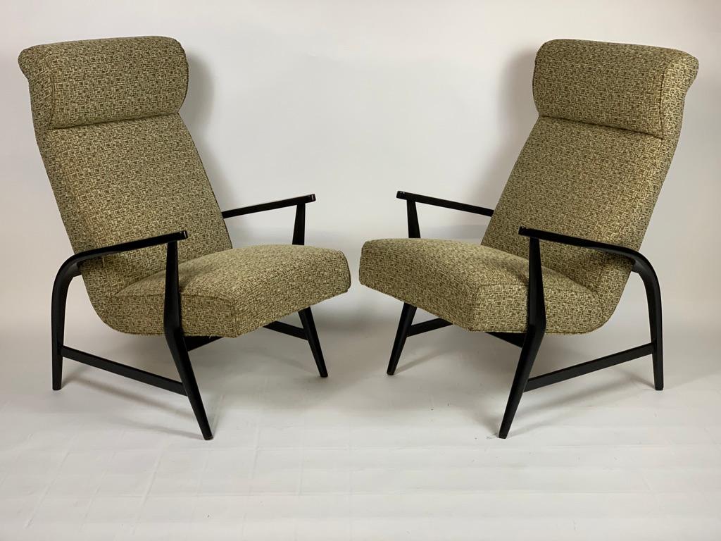 Comfortable pair of 1950s Italian armchairs with high back, black lacquered wooden structure and covered with original fabric with geometric abstract pattern typical of the time.
Italy Mid-Century Modern.
 