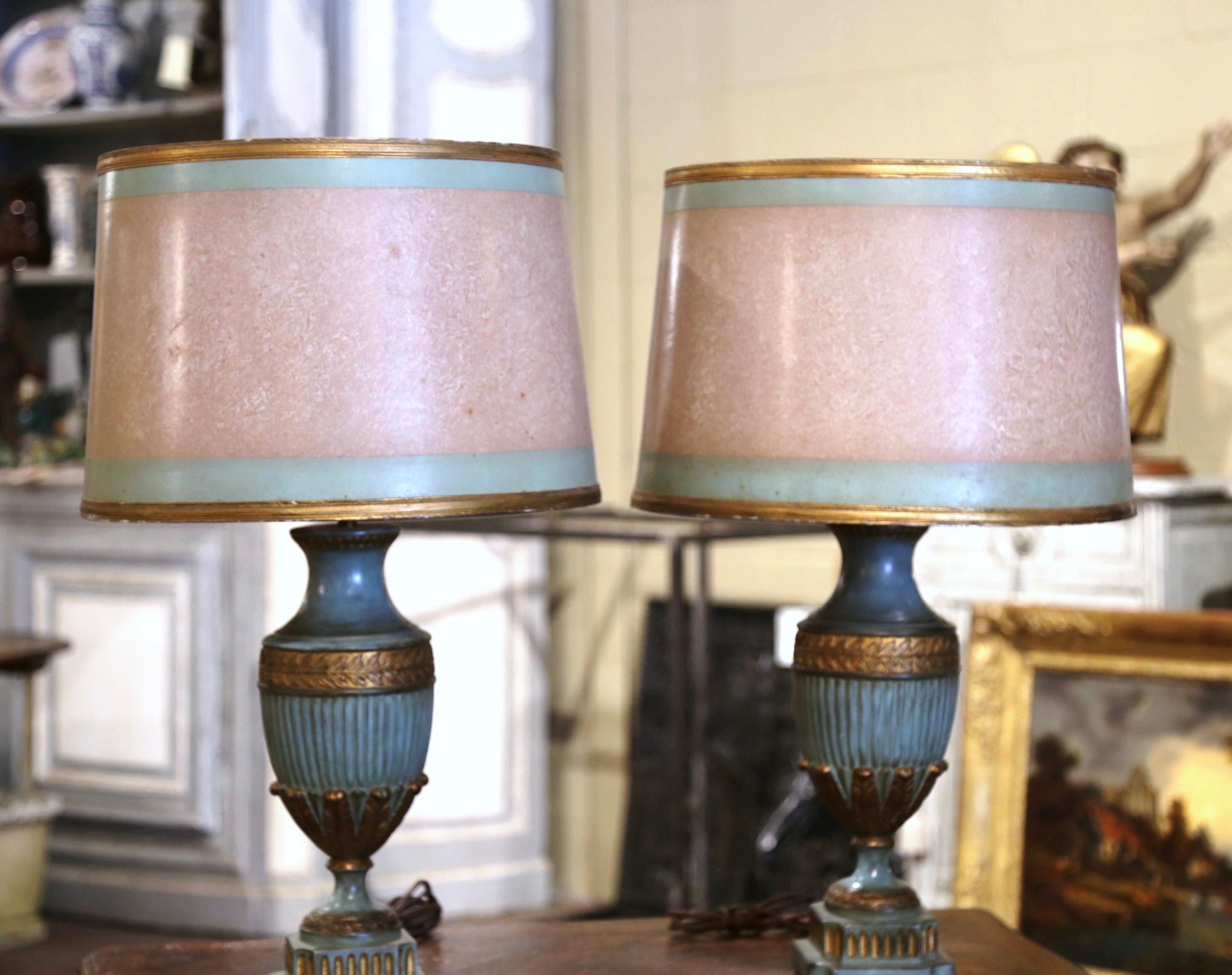 Incorporate extra light into a living room or bedroom with this elegant pair of colorful lamp bases. Crafted in Italy circa 1960, each lamp stands on an integral square base; the carved body in the neoclassical urn-shape form, and embellished with