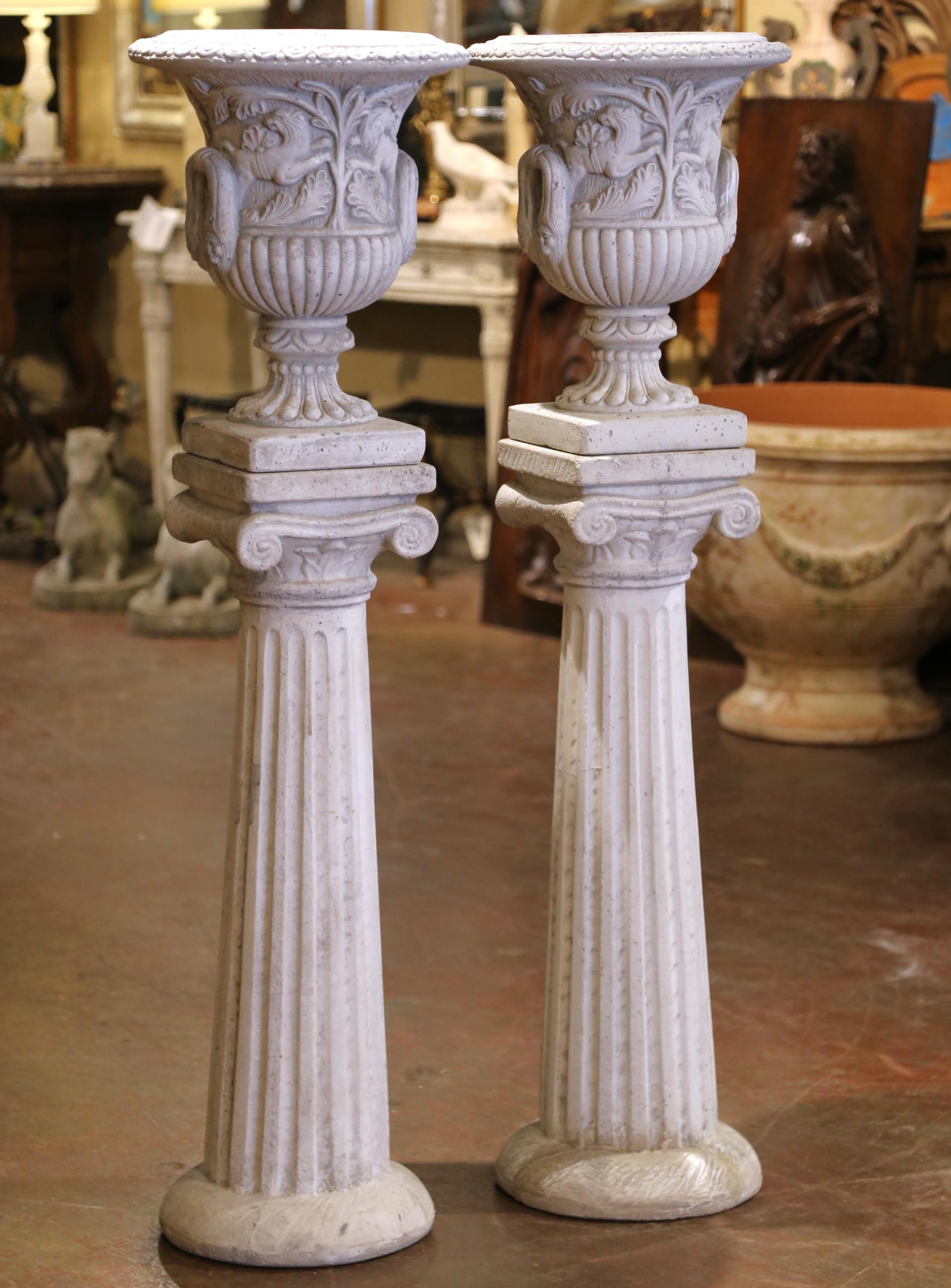 Questa coppia scultorea di urne da giardino in pietra fusa, ciascuna composta da un'urna classica che poggia su una base a piedistallo, è stata realizzata in Italia intorno al 1960 ed è firmata da Italgarden, un noto produttore italiano di ornamenti