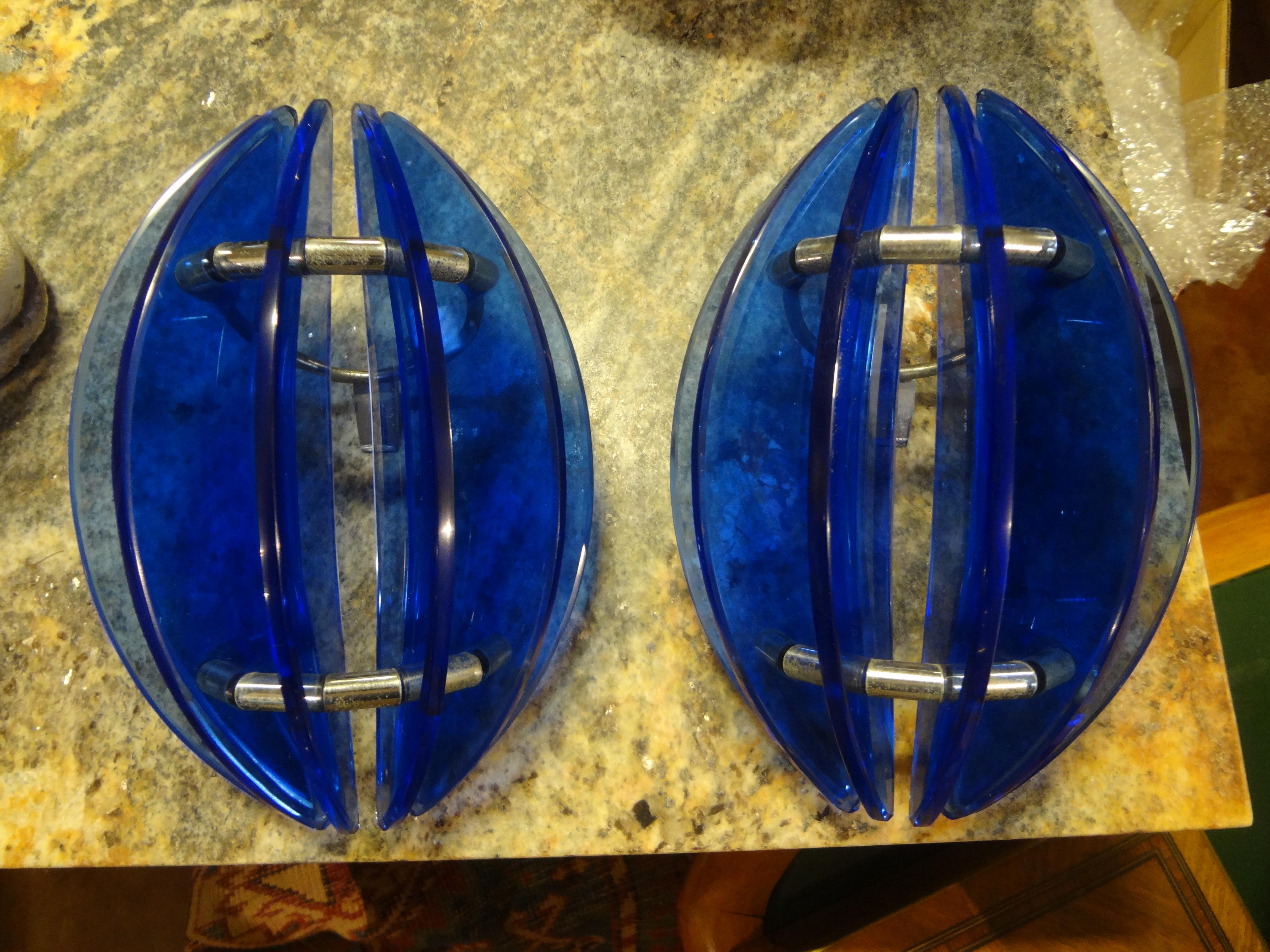Stunning pair of midcentury Italian cobalt blue glass sconces by Veca. These beautiful Italian Fontana Arte style sconces are comprised of sheets of cobalt blue glass on chrome structures. Our Italian modern glass sconces have been newly wired to