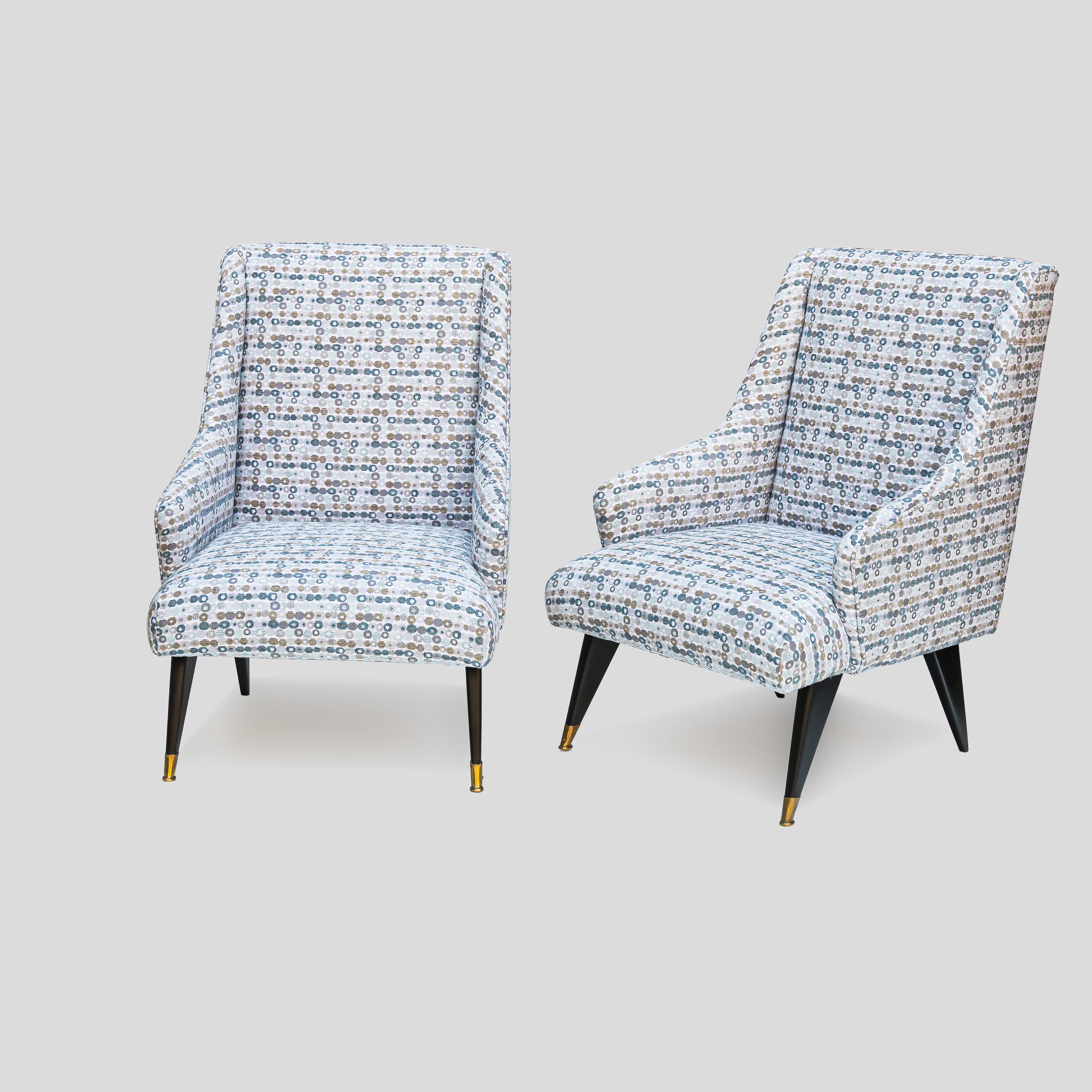 Pair of Mid century low seating armchairs recovered in Shannon splash powder teal fabric, black lacquered feet with brass metal ending front feet. Made in Italy ca. 1950s           

This chair is incredibly versatile and comfortable, perfect for