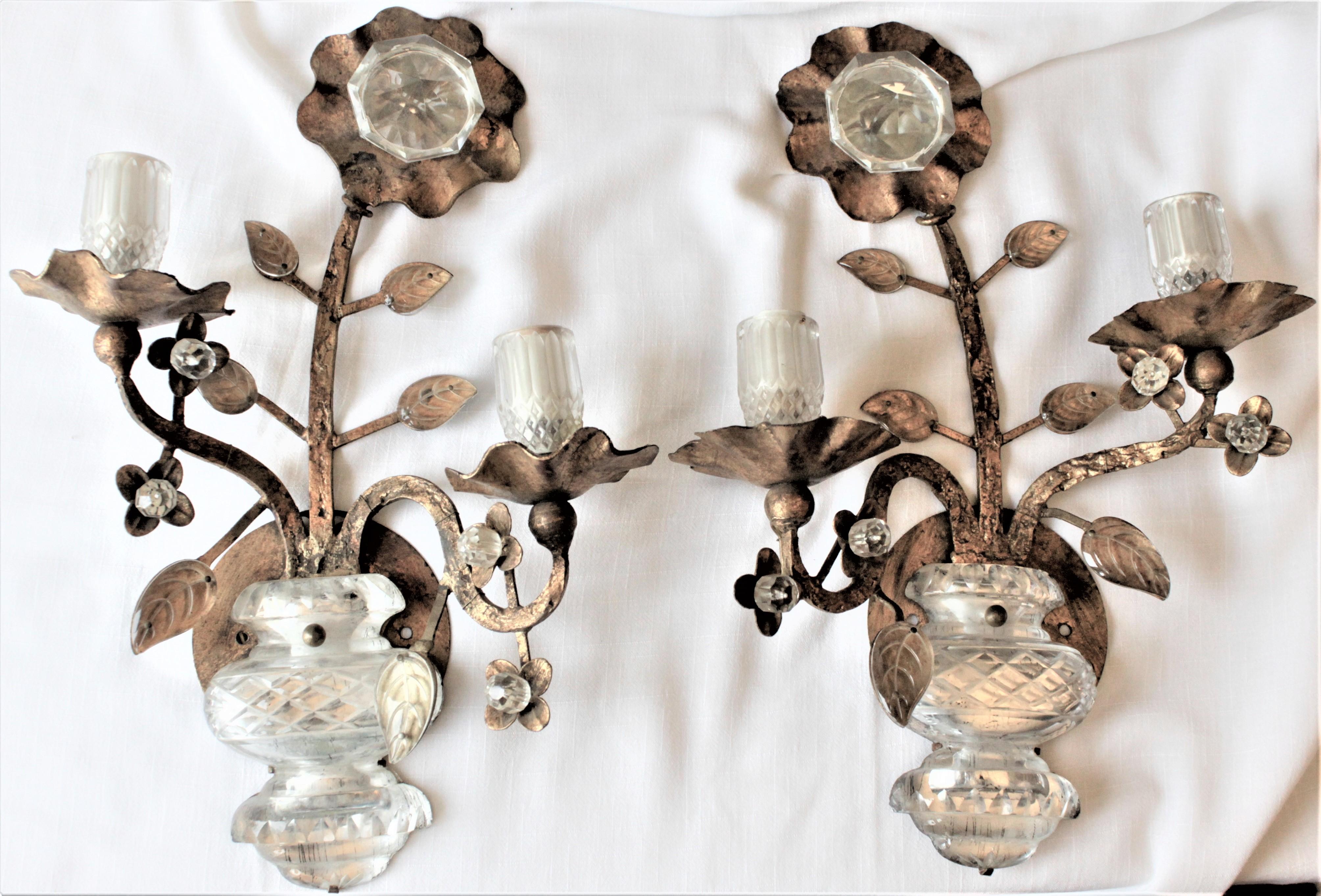 This pair of Mid-Century Modern gilt metal and glass wall sconces are unsigned but presumed to have been made in Italy in circa 1965. These sconces are done with a potted flowers motif using gilt finished metal with glass accents. The main flower is