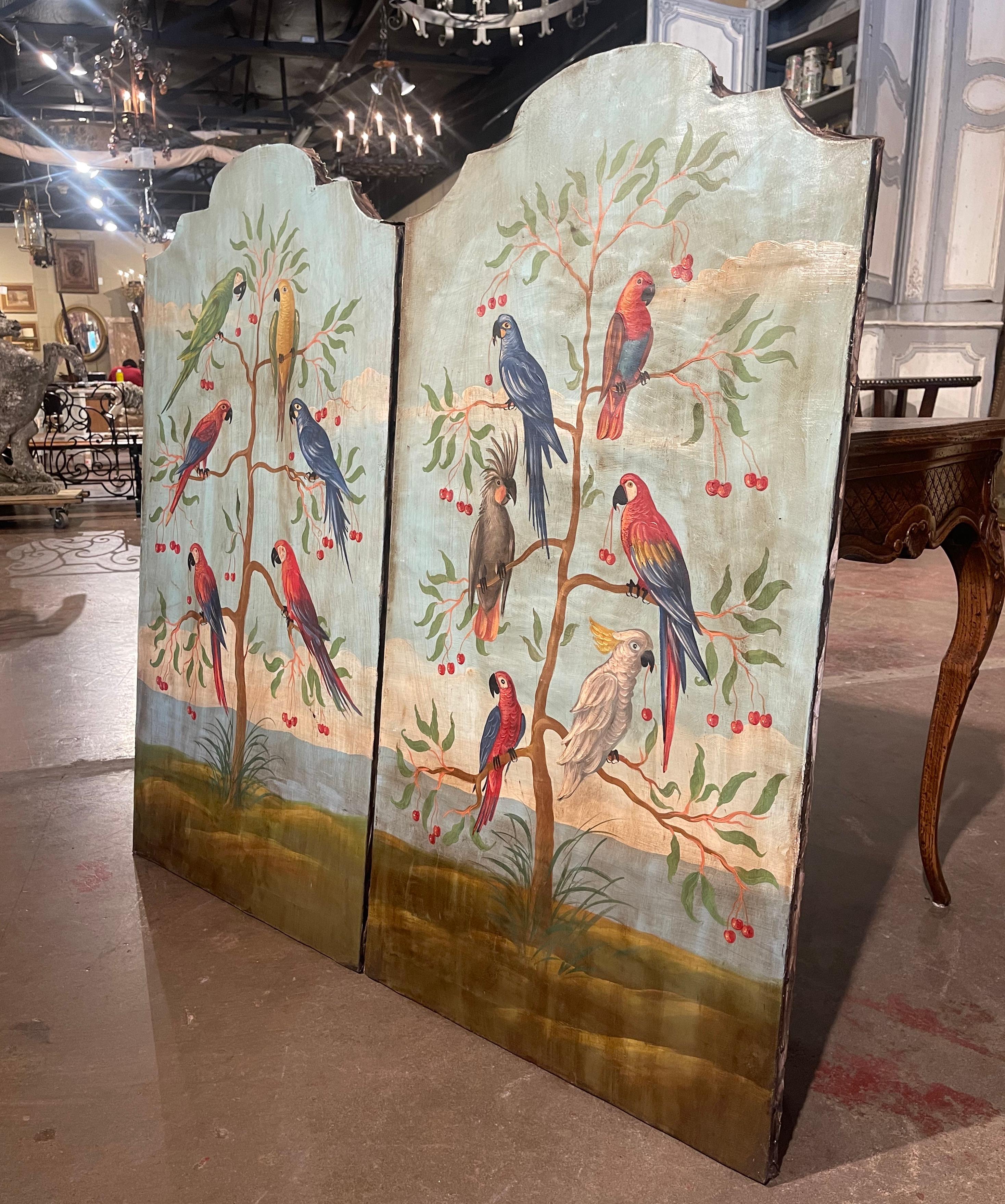 Decorate a living room, bedroom or den with this elegant pair of colorful parrot paintings! Crafted in Italy circa 1960, each hand painted canvas is set in a carved arched and scalloped frame. The first panel shows a greater sulphur-crested