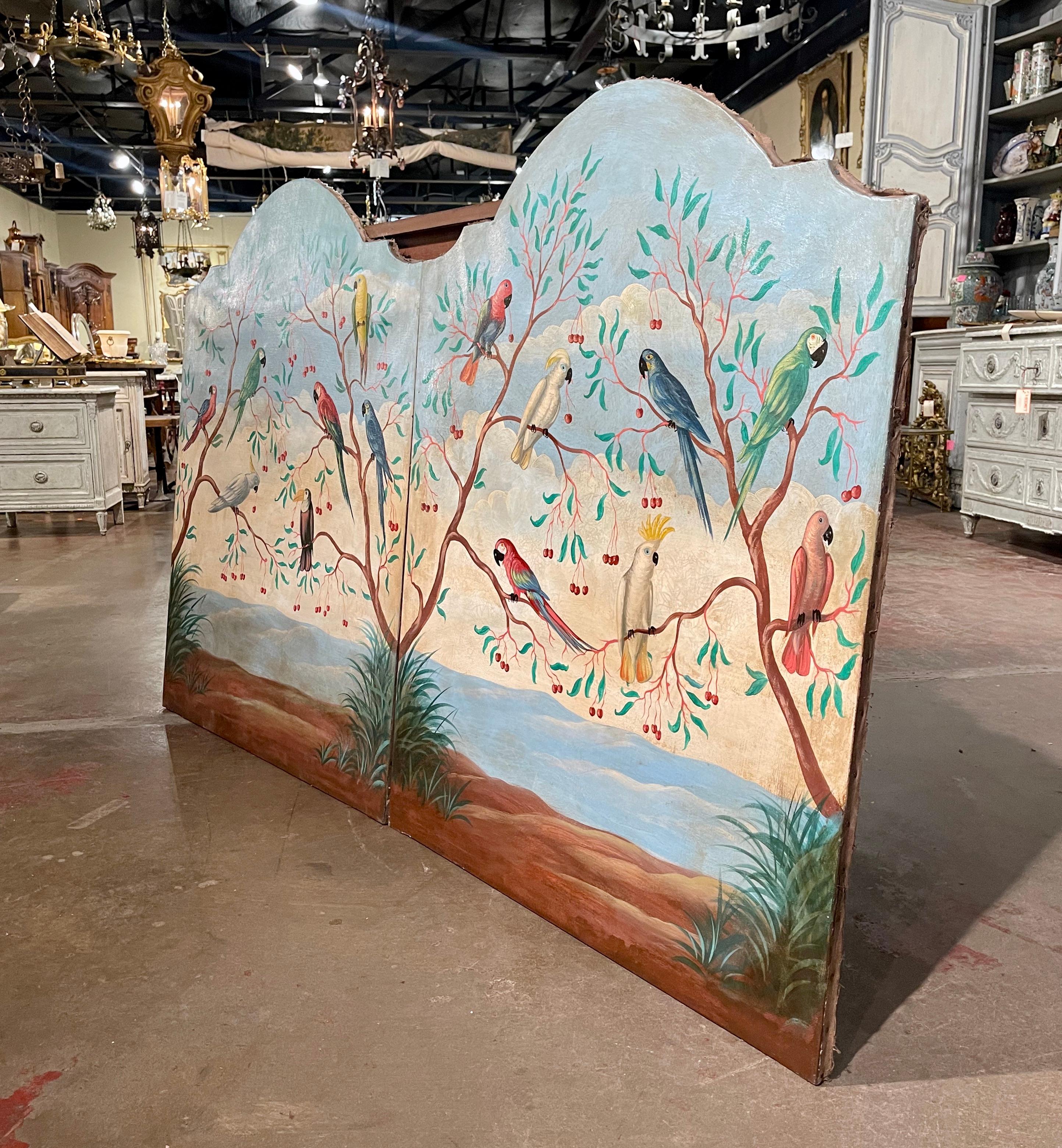Decorate a living room, bedroom or den with this elegant pair of colorful parrot paintings! Crafted in Italy circa 1960, each hand painted canvas is set in a carved arched and scalloped frame. The first panel features a scarlet macaw, illigers