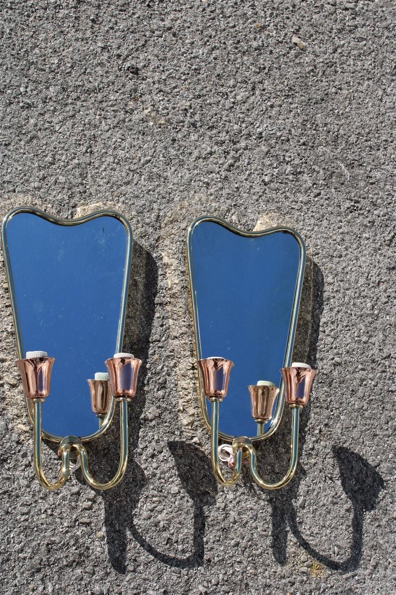 Delightful pair of mirrors with lights, albeit rare and of great Italian design, are very reminiscent of the style of the great Italian architect who made the history of Gio Ponti design, originals from around 1950, have been polished.