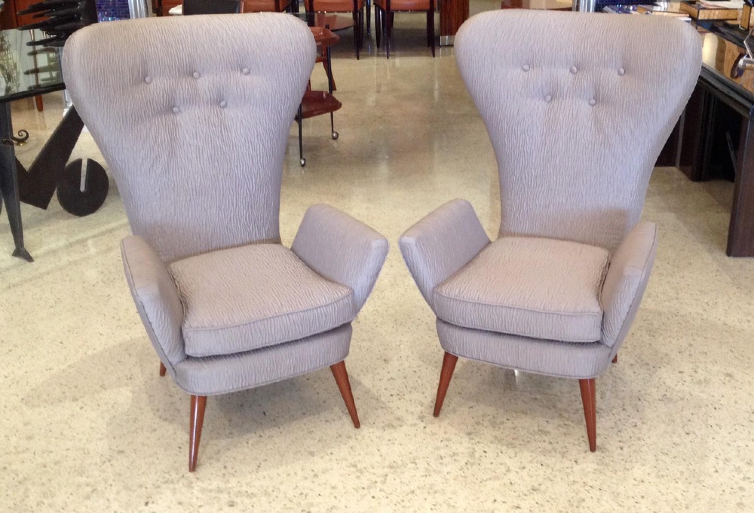 PAIR of Italian Modern armchairs with high fanned backs and angled armrests, upholstered in a gray textured fabric with button tufted detail and resting on four tapered walnut legs. (PRICED AS PAIR).