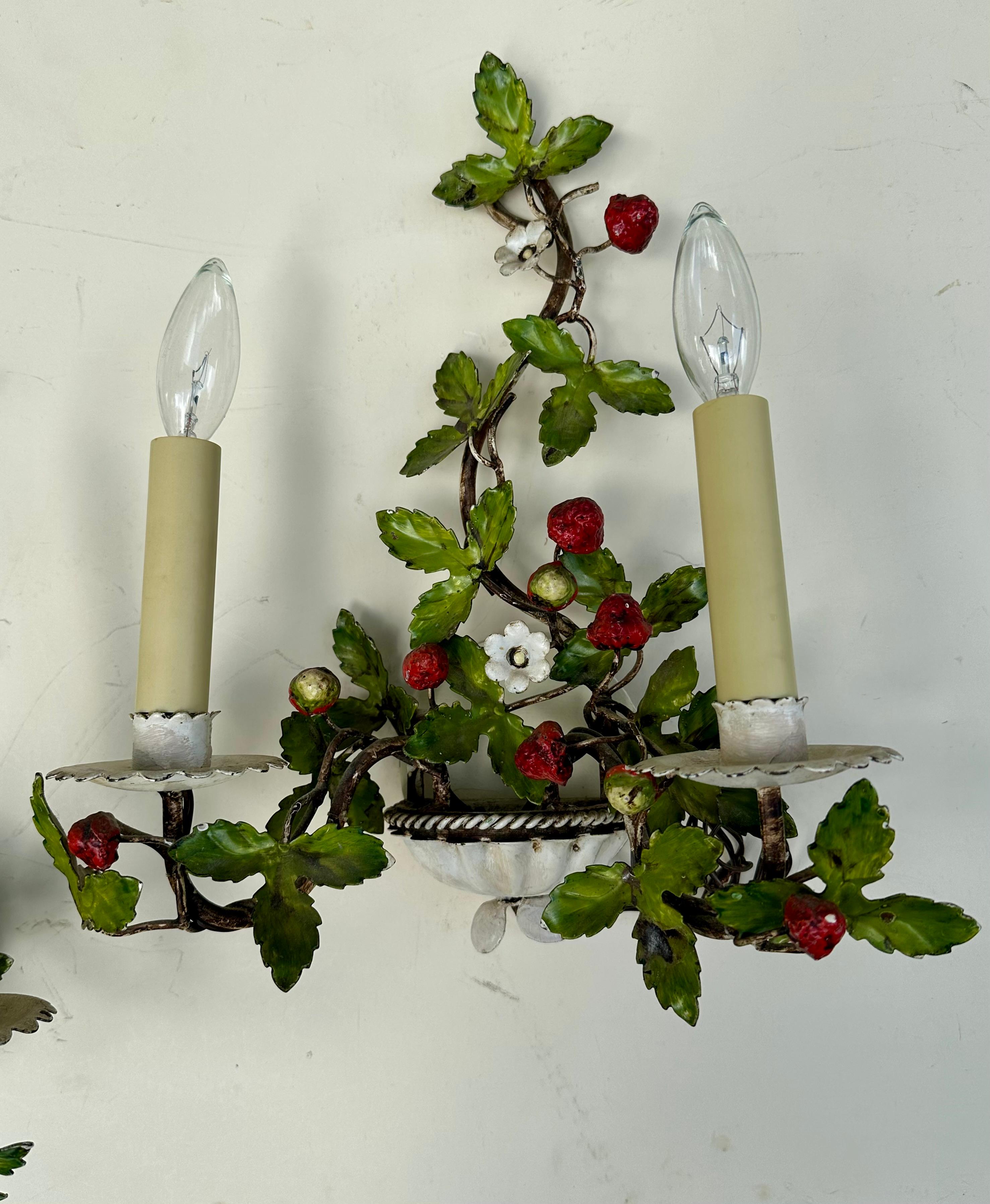 Pair of Mid-Century Italian Painted Tole Wild Strawberry Wall Sconces.

Pair of vintage electrified Italian hand painted tole sconces. They are naturalistically 
designed with double branches, white flowers and a profusion of leaves. Hand painted