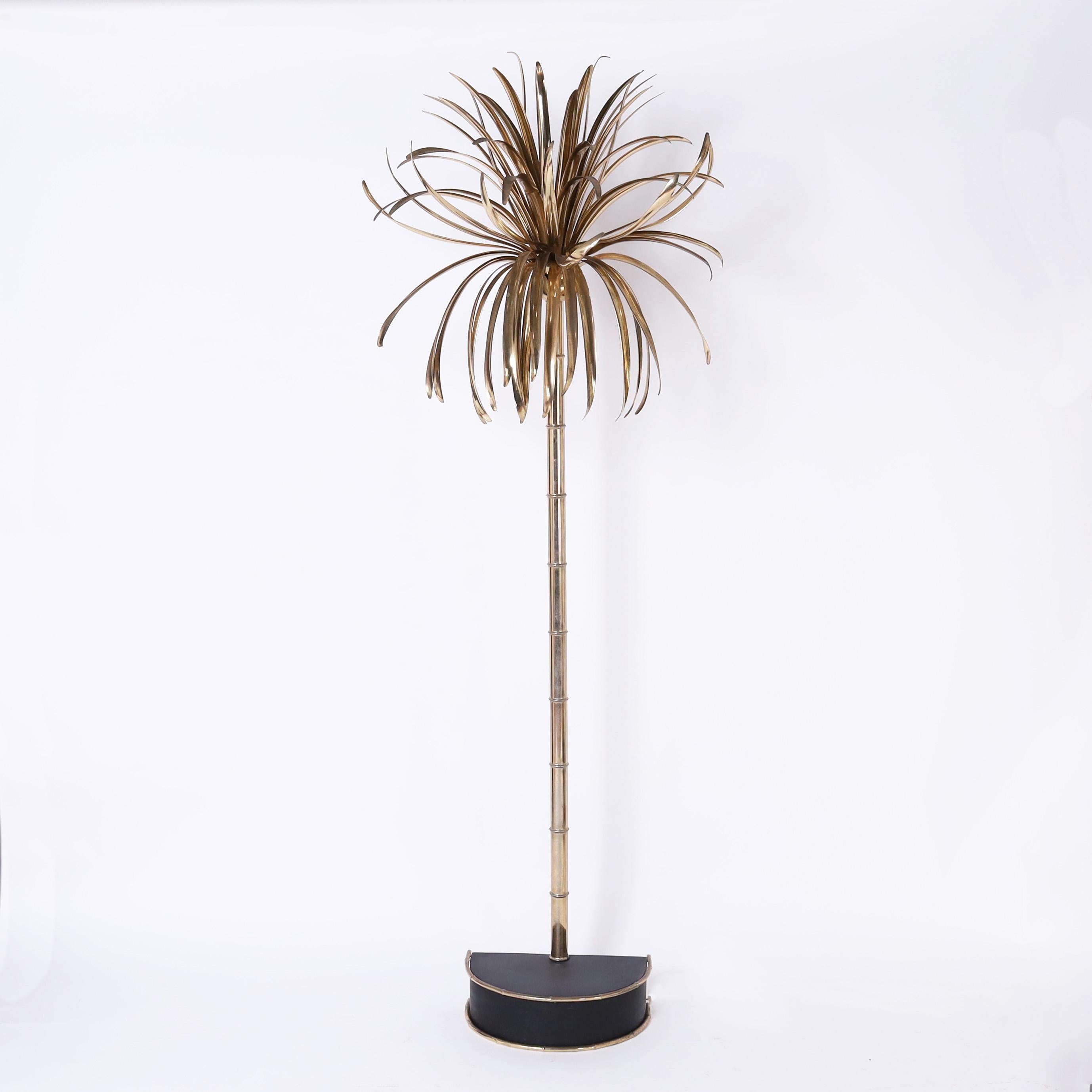 Chic pair of mid century Italian floor lamps crafted with brass plated metal in a stylized palm tree form on a black lacquered demilune base with faux bamboo trim. Signed Casa Bique on the backs. 