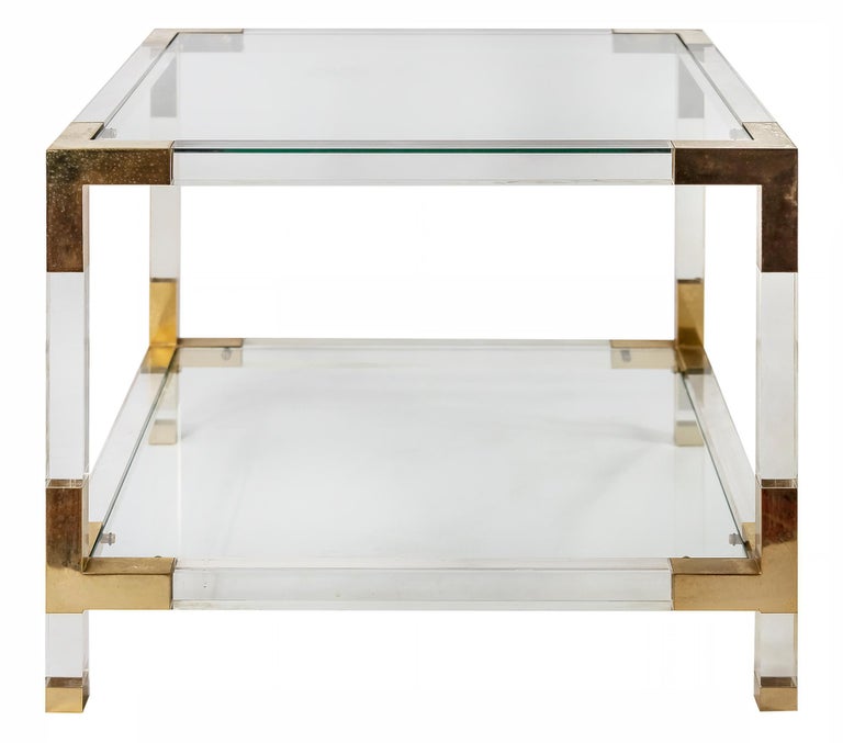 Pair of mid-century Italian side/sofa tables in plexiglass and gilded metal with glass top and lower shelve.
Lebel: Sciolari Roma.
 