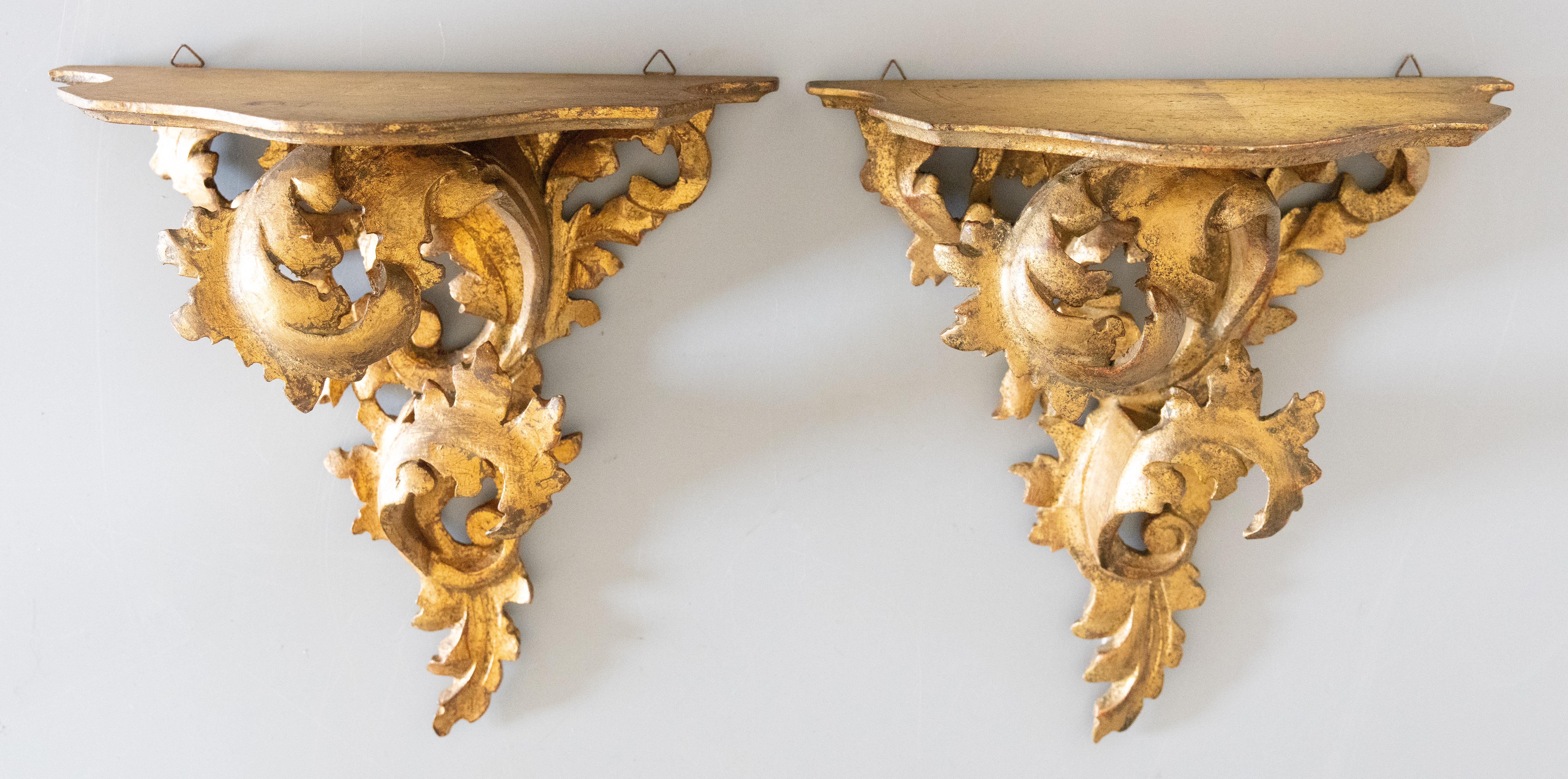 A lovely pair of Mid-Century Italian Florentine gilded wood wall brackets shelves. One bracket is stamped 