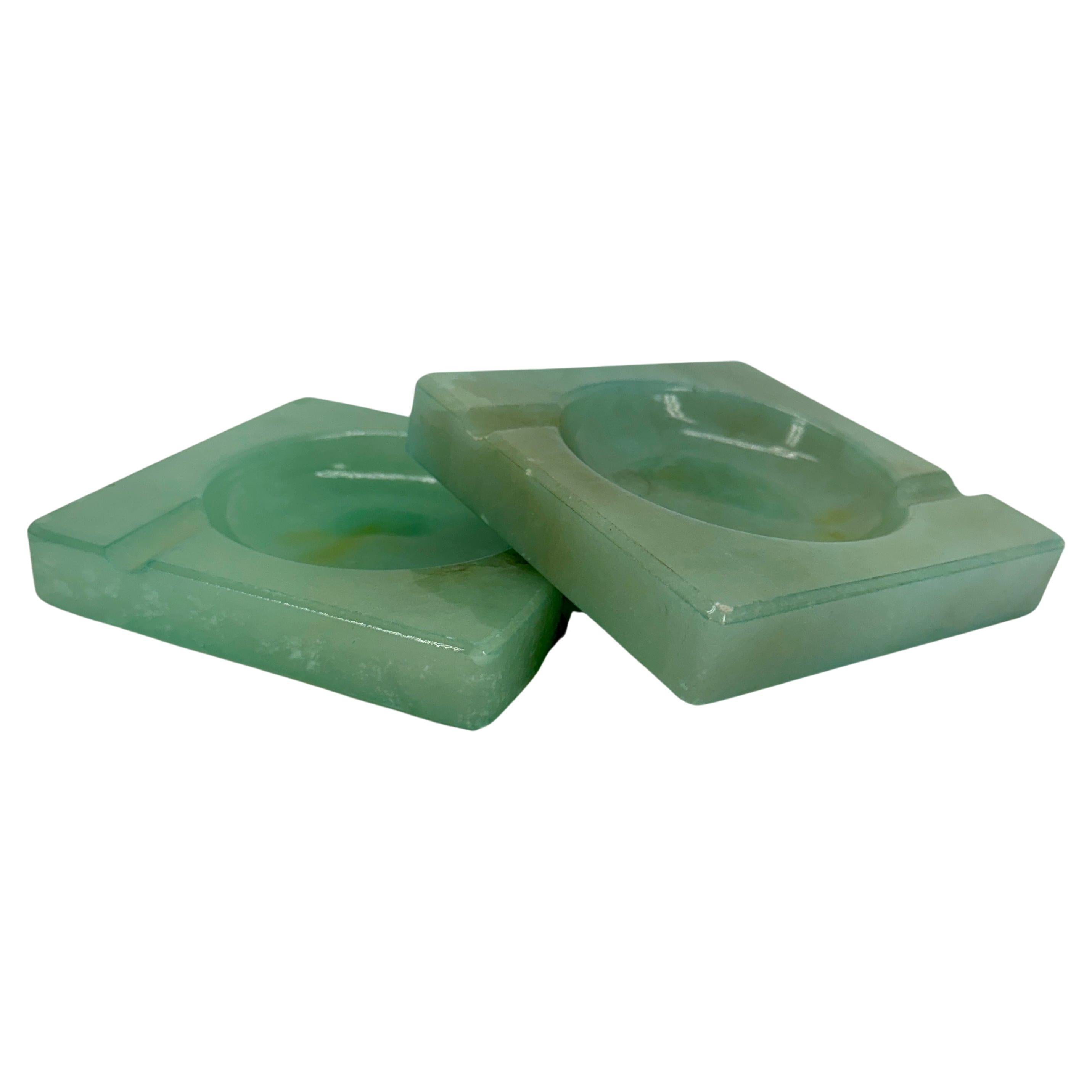 MCM Hand-Carved Green Alabaster Ashtrays, Italy

Classic pair, in a wonderful shade of green, Alabaster ashtrays from Italy. These original decorative objects appear to have never been used. Wonderful set displayed on a MCM coffee table, side table