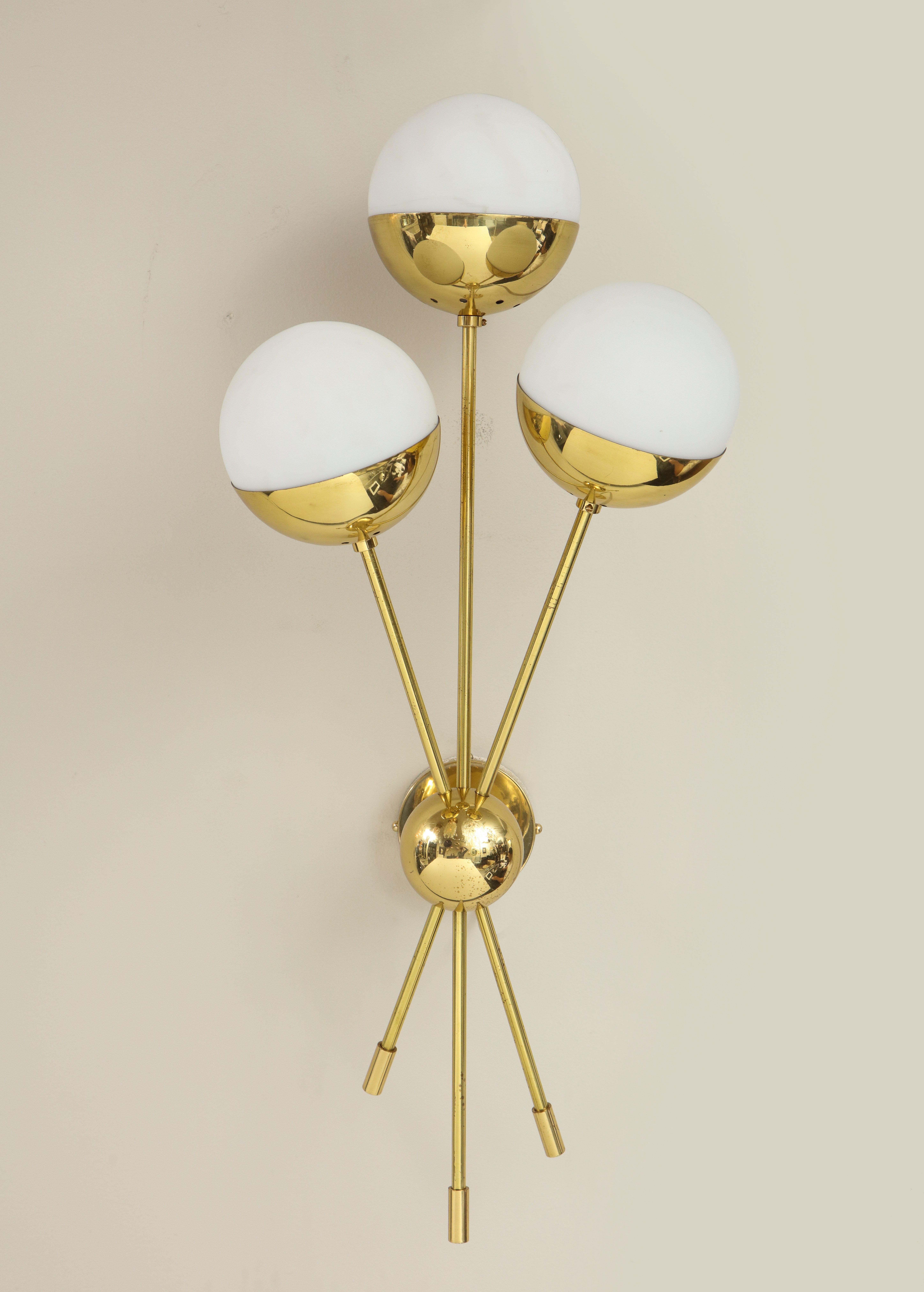 A chic pair of vintage Stilnovo sconces with 3 opaline globes in polished brass. The sconces has been rewired for the U.S standard. slight aging showing on brass finish that is consistent with age.