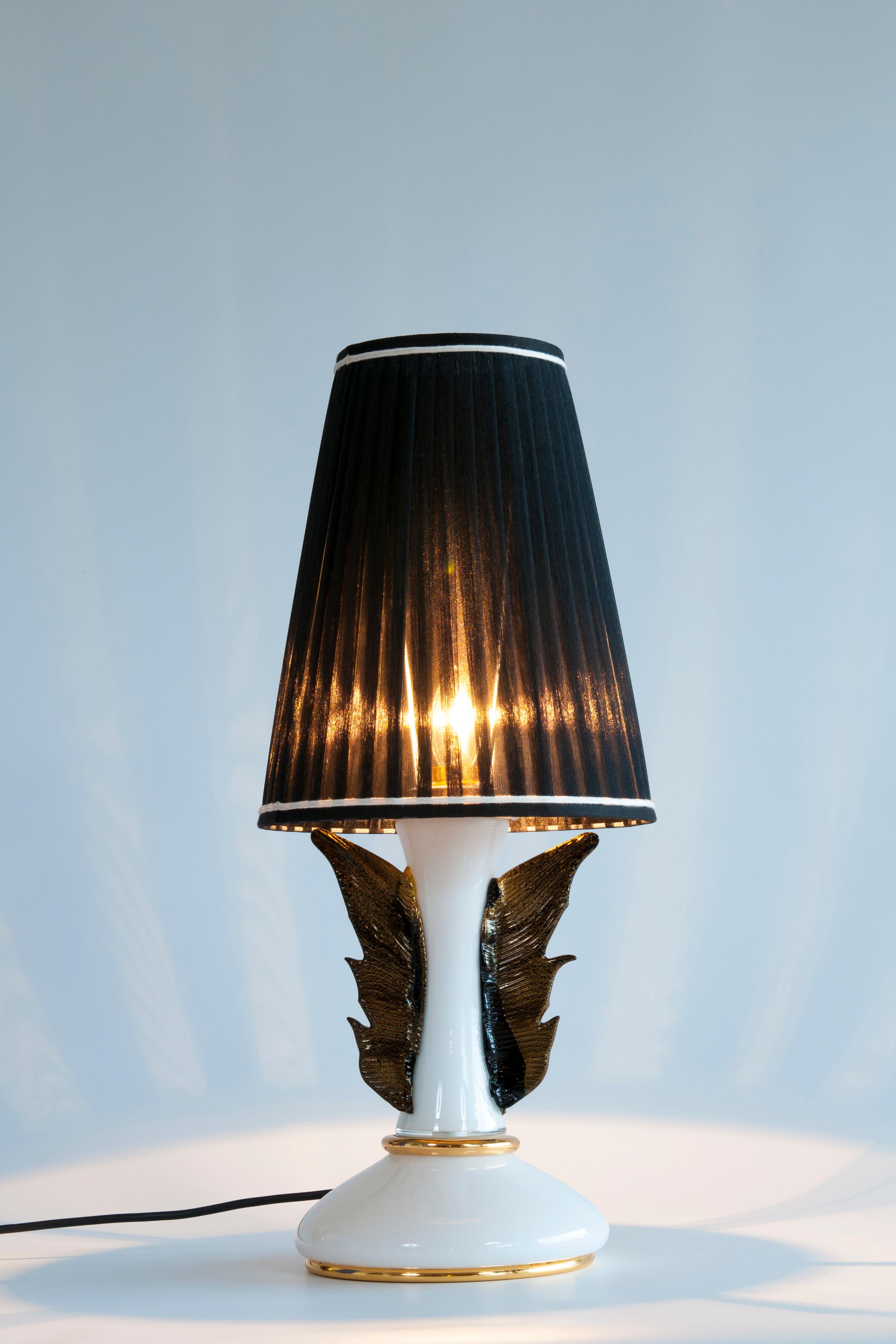 An exceptional and highly sought-after pair of table lamps, embodying the pinnacle of Italian artistry and glamorous 1970s design. Masterfully executed in Murano glass by the renowned artist Giovanni Dalla Fina, these pieces transcend mere lighting,