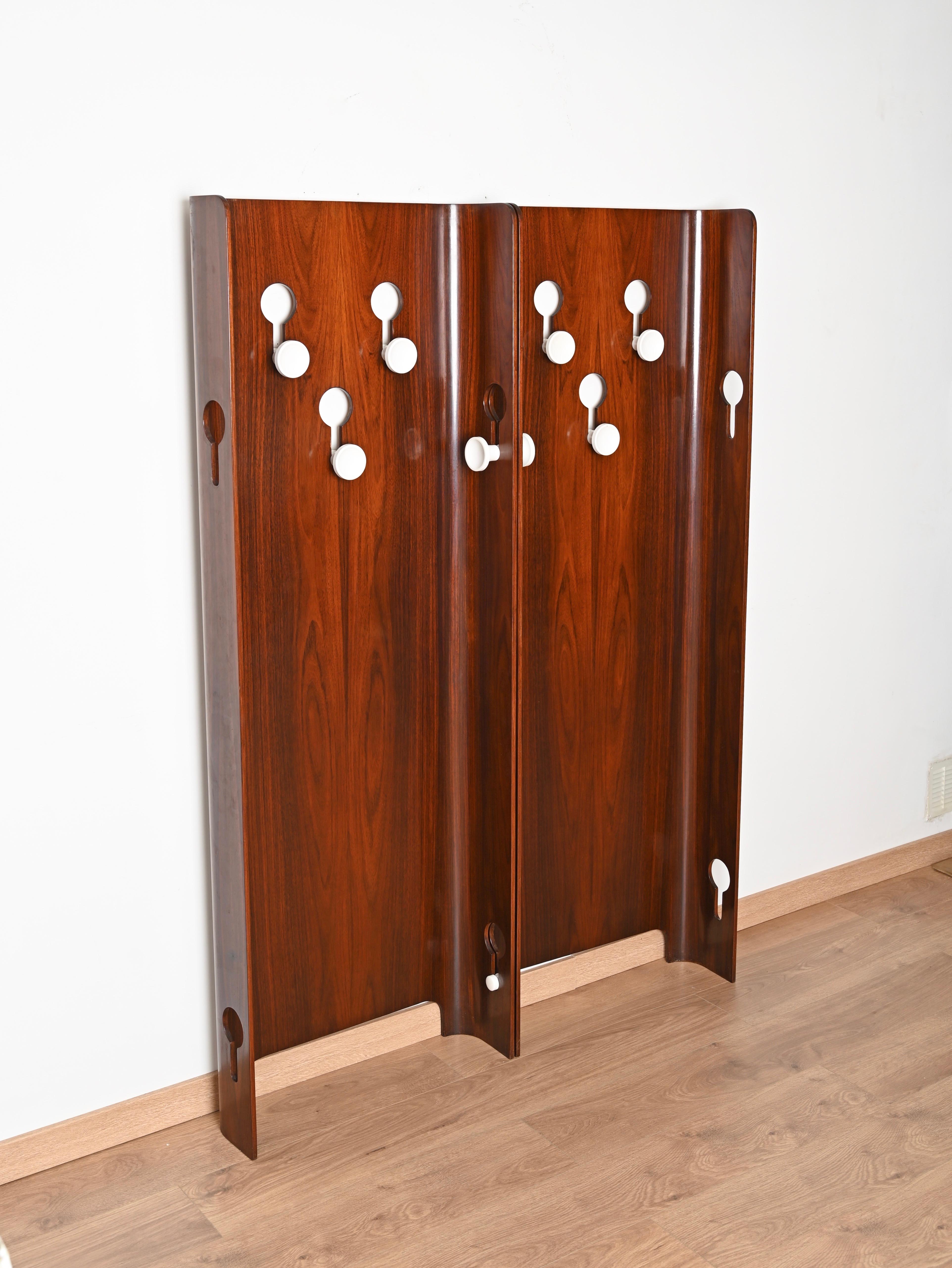 Deightful pair of coat hangers in teak wood. These stunning coat racks were designed in Italy by Carlo de Carli for Fiarm during the 1960s and are signed on the back. 

Fully original and in extraordinary conditions, with no flaws. The wood used by