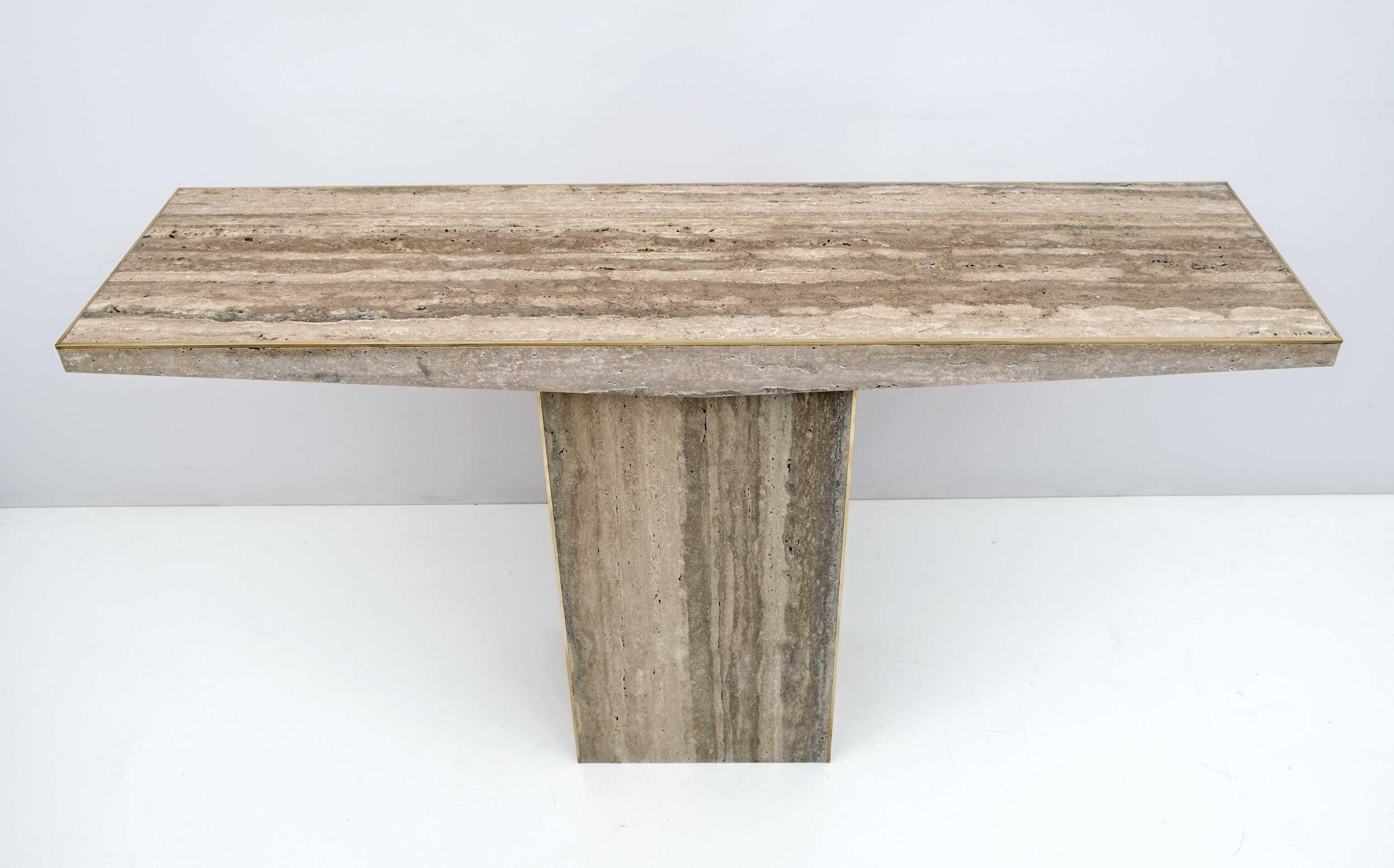 Pair of mid-century Italian travertine console tables.
Sanded, unfilled finish.
Decorative fine brass finish surrounding the top and bottom.

The price is for each.